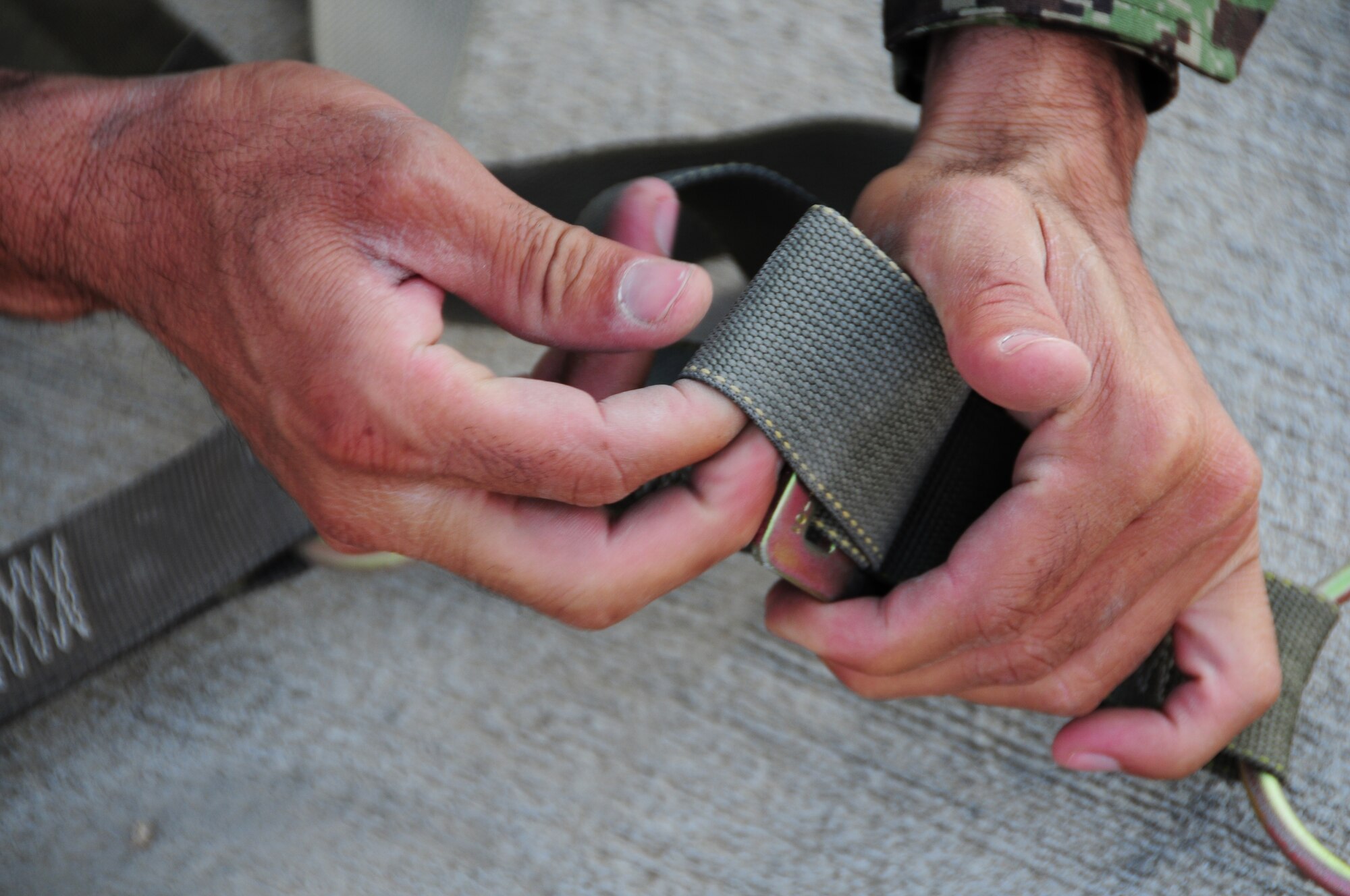 An Airman from the Afghan Air Force prepares cargo netting for a recent shipment of AAF helicopter parts at Kabul International Airport, Kabul, Afghanistan, June 6, 2011. Deployed Airmen here at the 438th Air Expeditionary Wing, are responsible for setting the conditions for a professional, fully independent and operationally-capable Afghan Air Force. (U.S. Air Force photo by Senior Airman Amber Williams)
