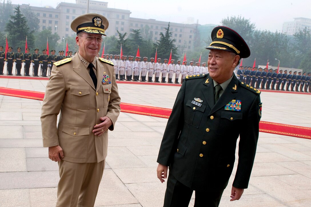 Chinese Gen. Chen Bingde, Chief of the People's Liberation Army's General Staff, greets U.S. Navy Adm. Mike Mullen, chairman of the Joint Chiefs of Staff, in Beijing, July 11, 2011.