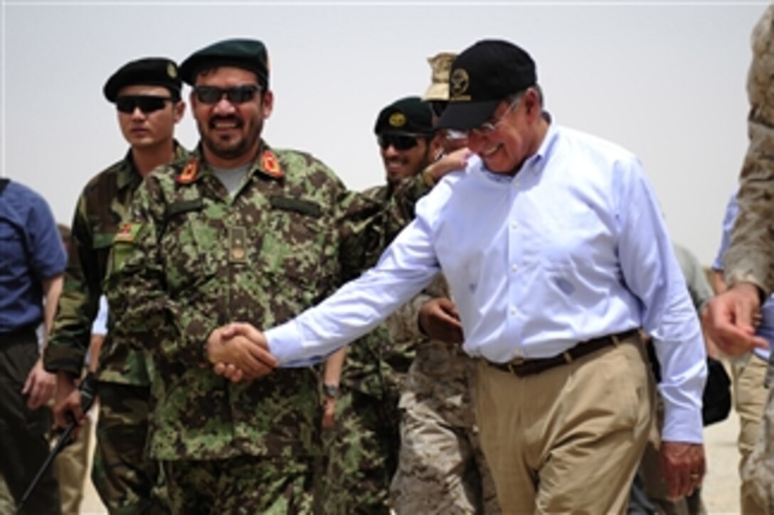 Secretary of Defense Leon E. Panetta shakes hands with the commander of Afghanistan Garrison Support Unit 1-215, Embedded Training Team, at Camp Dwyer, Afghanistan, on July 10, 2011.  