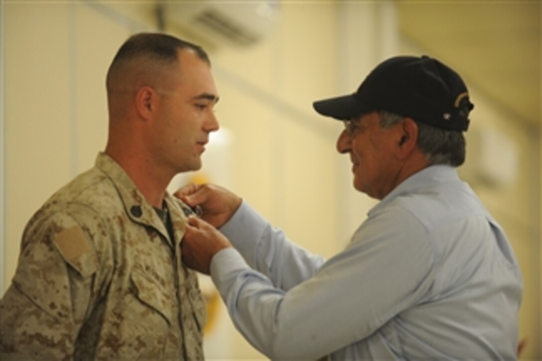 Secretary of Defense Leon E. Panetta awards U.S. Marine Shawn Vernon, Combat Logistics Battalion-7, the Purple Heart at Camp Dwyer, Afghanistan, on July 10, 2011.  