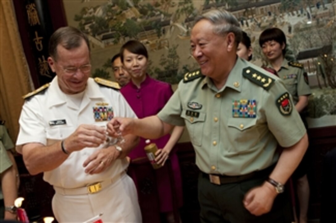 Chairman of the Joint Chiefs of Staff Adm. Mike Mullen and Chief of the Peoples Liberation Army's General Staff Gen. Chen Bingde toast during dinner in Beijing, China, on July 10, 2011.  Mullen is on a three-day trip to the country meeting with counterparts and Chinese leaders.  