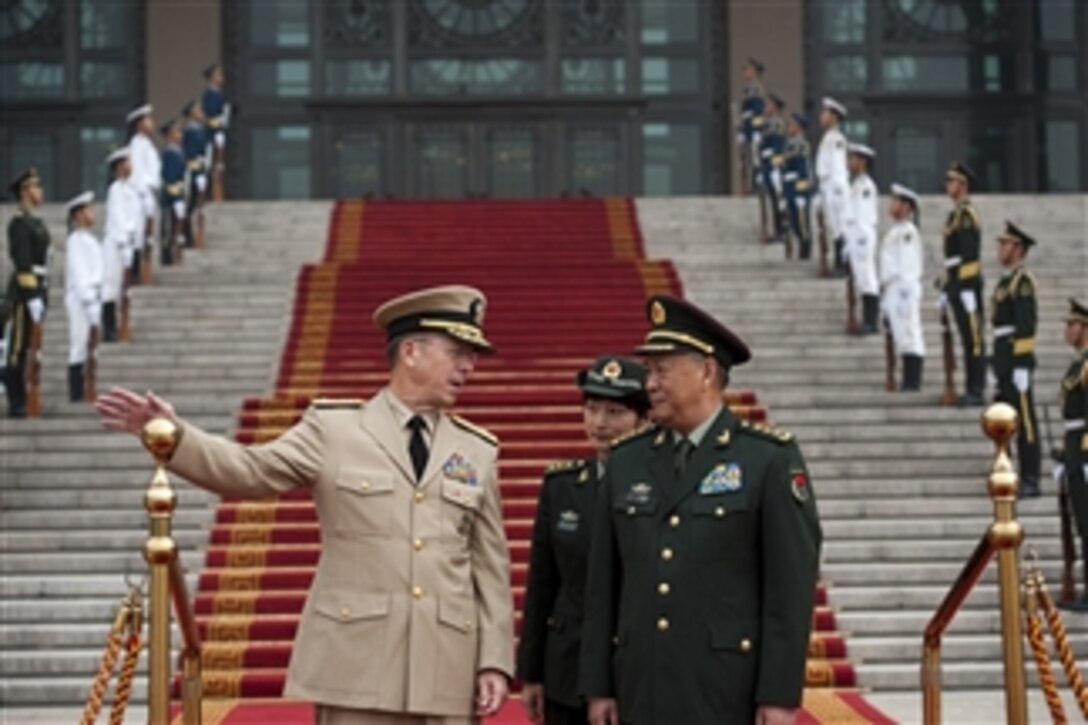 Chairman of the Joint Chiefs of Staff Adm. Mike Mullen speaks with Chief of the Peoples Liberation Army's General Staff Gen. Chen Bingde during a ceremony welcoming Mullen to Beijing, China, on July 11, 2011.  Mullen is on a three-day trip to the country meeting with counterparts and Chinese leaders.  