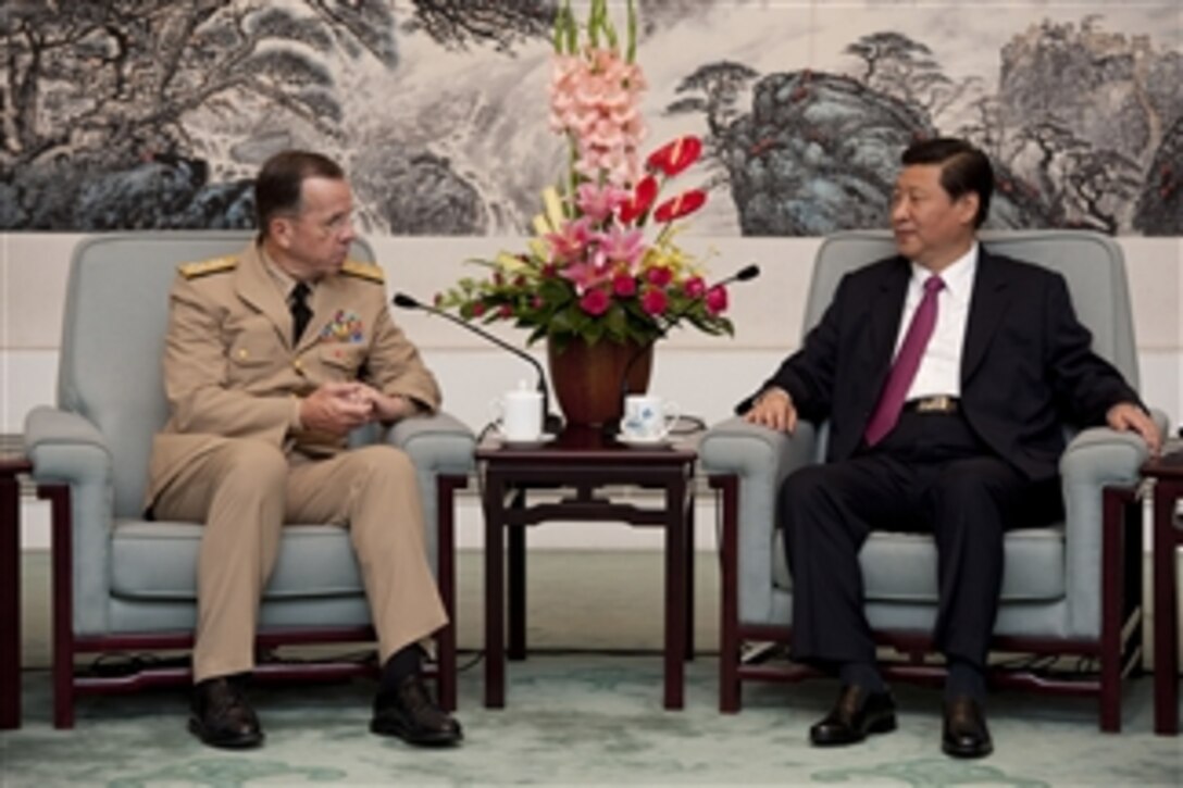 Chairman of the Joint Chiefs of Staff Adm. Mike Mullen speaks with Chinese Vice President Xi Jinping in Beijing on July 11, 2011.  Mullen is on a three-day trip to the country meeting with counterparts and Chinese leaders.  