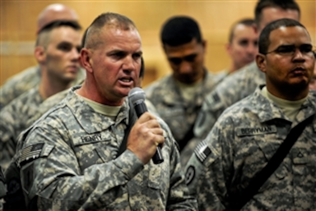 A soldier poses a question to U.S. Defense Secretary Leon E. Panetta at Camp Victory, Iraq, July 11, 2011.