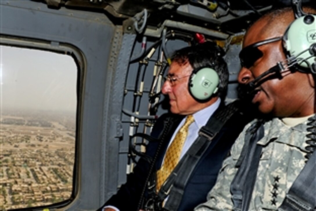 U.S. Defense Secretary Leon E. Panetta rides aboard a UH-60 Black Hawk helicopter with U.S. Army Gen. Lloyd J. Austin III, commander of U.S. Forces Iraq, over Baghdad on their way to meetings with Iraqi Prime Minister Nouri al-Maliki and President Jalal Talabani, July 11, 2011.