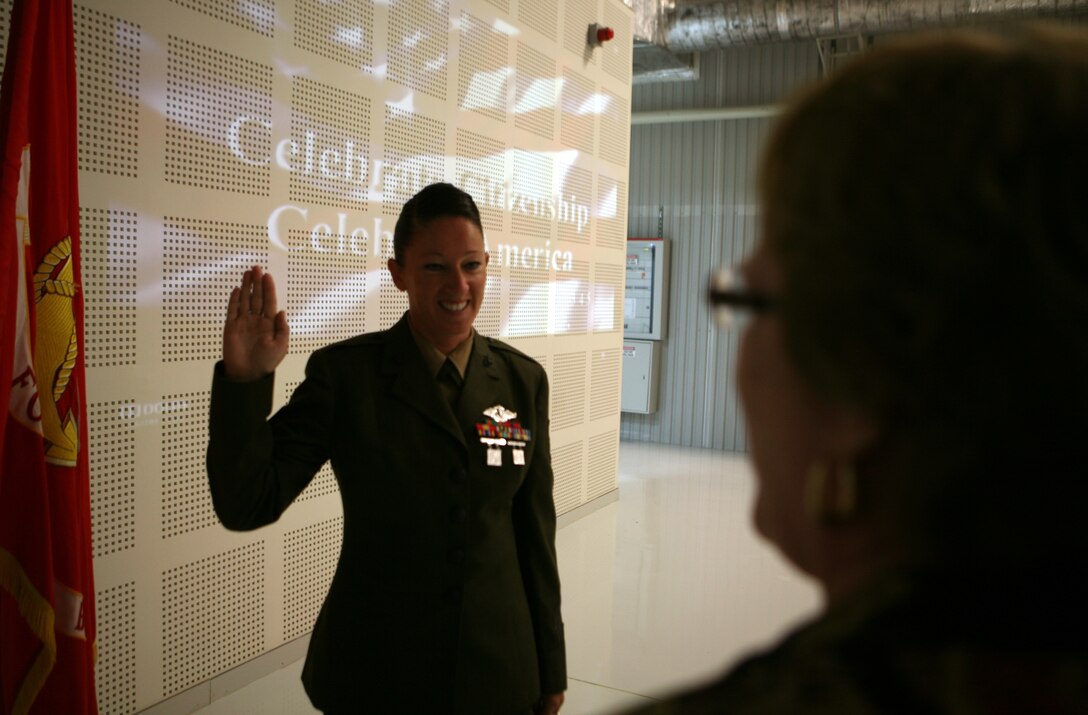 During a naturalization ceremony here, Pamela G. Hutchings, field program director of U.S. Citizenship and Immigration Services office in Vienna, Austria, leads Hospital Corpsman 2nd Class Anastatia M. Dobbs, as she pledges the Oath of Allegiance and officially becomes a U.S. citizen while deployed to Romania. A Navy corpsman for Black Sea Rotational Force 11 with almost 10 years of service, Dobbs’ naturalization ceremony marks the first time a U.S. servicemember has sworn-in to become an American citizen in Romania. The USCIS made a visit to Mihail Kogalniceanu Land Forces base to conduct the ceremony, and has naturalized a total of more than 53,400 members of the U.S. armed forces since September 2001, with over 7,400 being on foreign soil. ::r::::n::