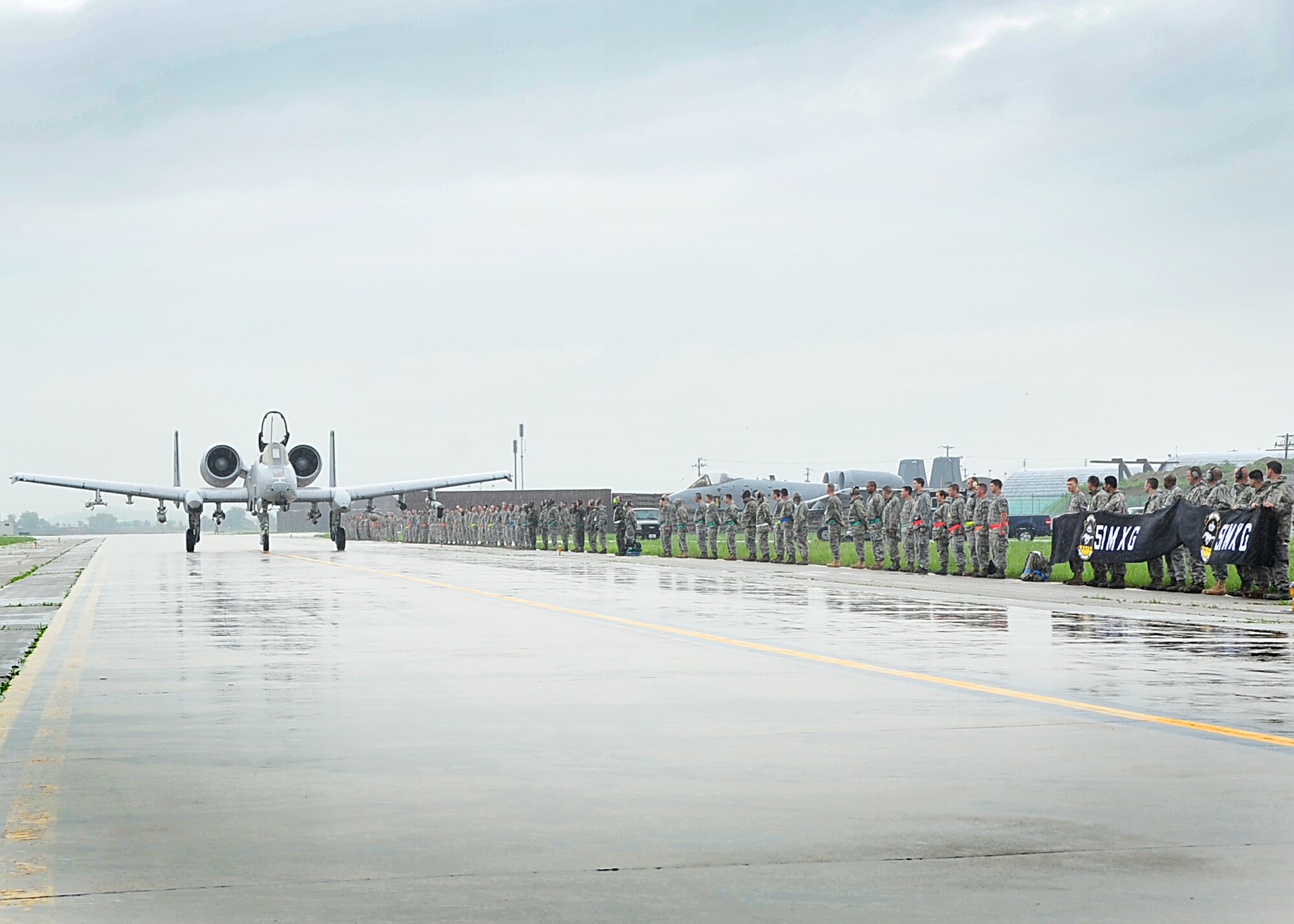 Col. Patrick Malackowski took his final flight as the 51st Fighter Wing commander here July 12.  Members of the 51st Maintenance Squadron line up and say farewell during the wing commander's last stroll down the flight-line.  Colonel Malackowski served as wing commander of the 51st FW since December 2009.  He and his family will depart Osan Air Base, Republic of Korea and head to Hickam Air Force Base, Hawaii, where he will become the 13th Air Force vice commander.  (U.S. Air Force Photos by/Staff Sgt. Daylena Gonzalez)
