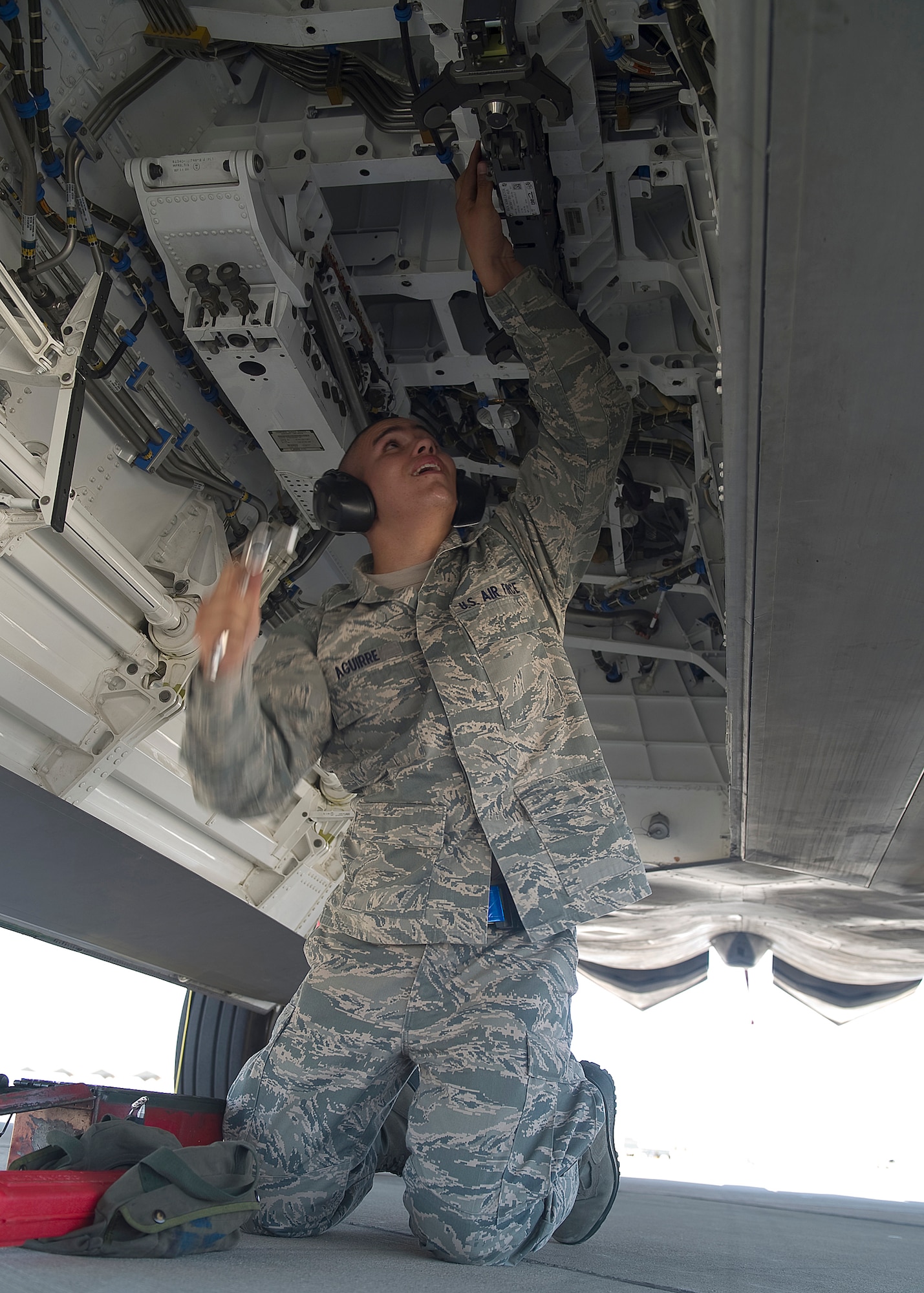 HOLLOMAN AIR FORCE BASE, N.M. -- Airman 1st Class Eric Aguirre, 49th Aircraft Maintenance Squadron, prepares to ratchet a bolt under an F-22 Raptor in preparation to load a GBU-32 bomb during a load crew competition July 8, 2011, outside of Hangar 301. Aguirre’s crew loaded a GBU-32 and an AIM-9 sidewinder during the competition. This particular competition marked the first time a German Air Force load crew participated with the 49th Maintenance Squadron’s crews.  (U.S. Air Force photo by Senior Airman John D. Strong II/Released)