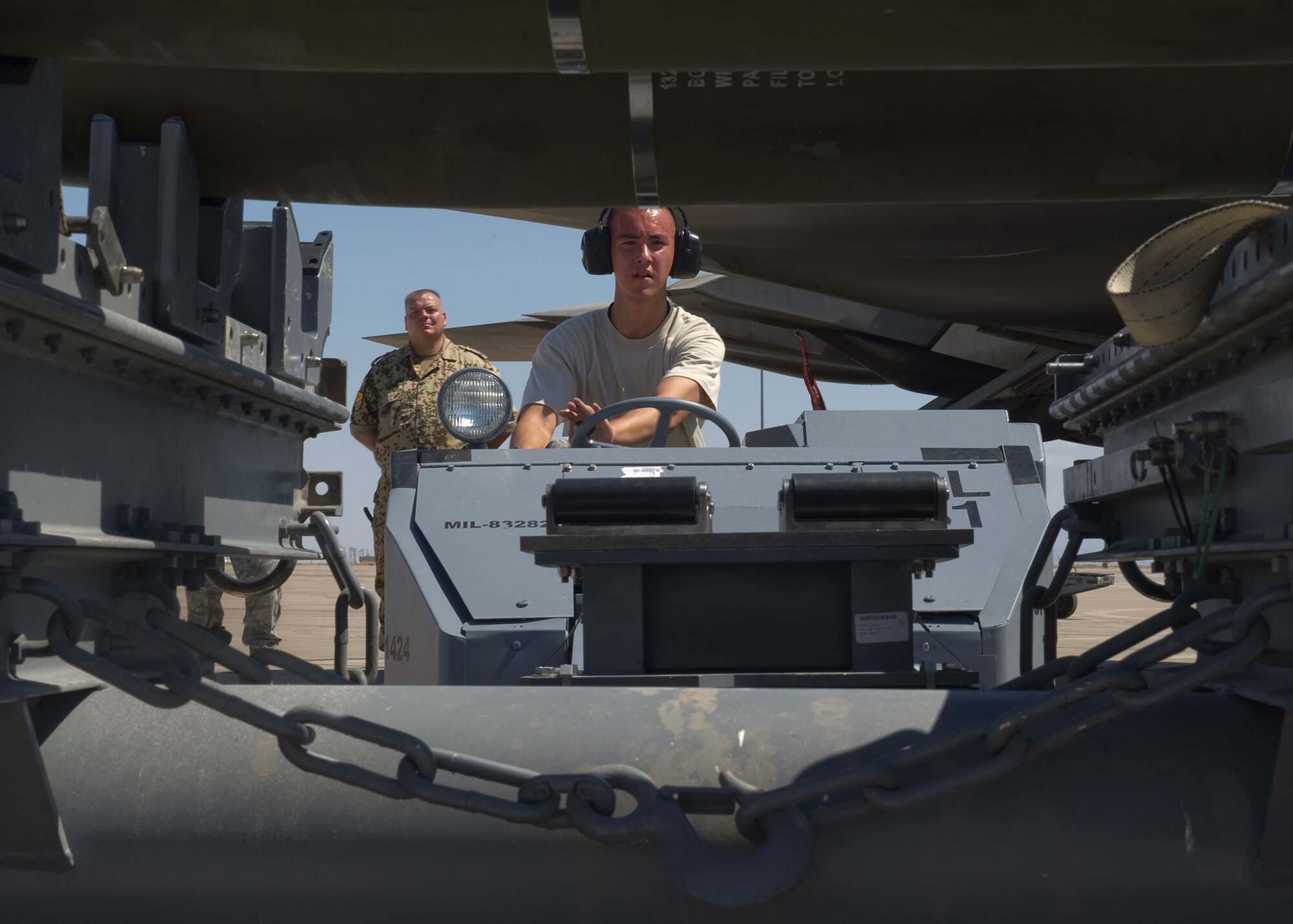 HOLLOMAN AIR FORCE BASE, N.M. -- Staff Sgt. Jessie Docking, Senior Airman Eric Bucholz and Airman 1st Class Eric Aguirre, all with the 49th Aircraft Maintenance Squadron, lift and carry an AIM-9 sidewinder during a load crew competition July 8, 2011, outside of Hangar 301. The crew loaded a GBU-32 bomb and an AIM-9 sidewinder during the competition. This particular competition marked the first time a German Air Force load crew participated with the 49th Maintenance Squadron’s crews.  (U.S. Air Force photo by Senior Airman John D. Strong II/Released)