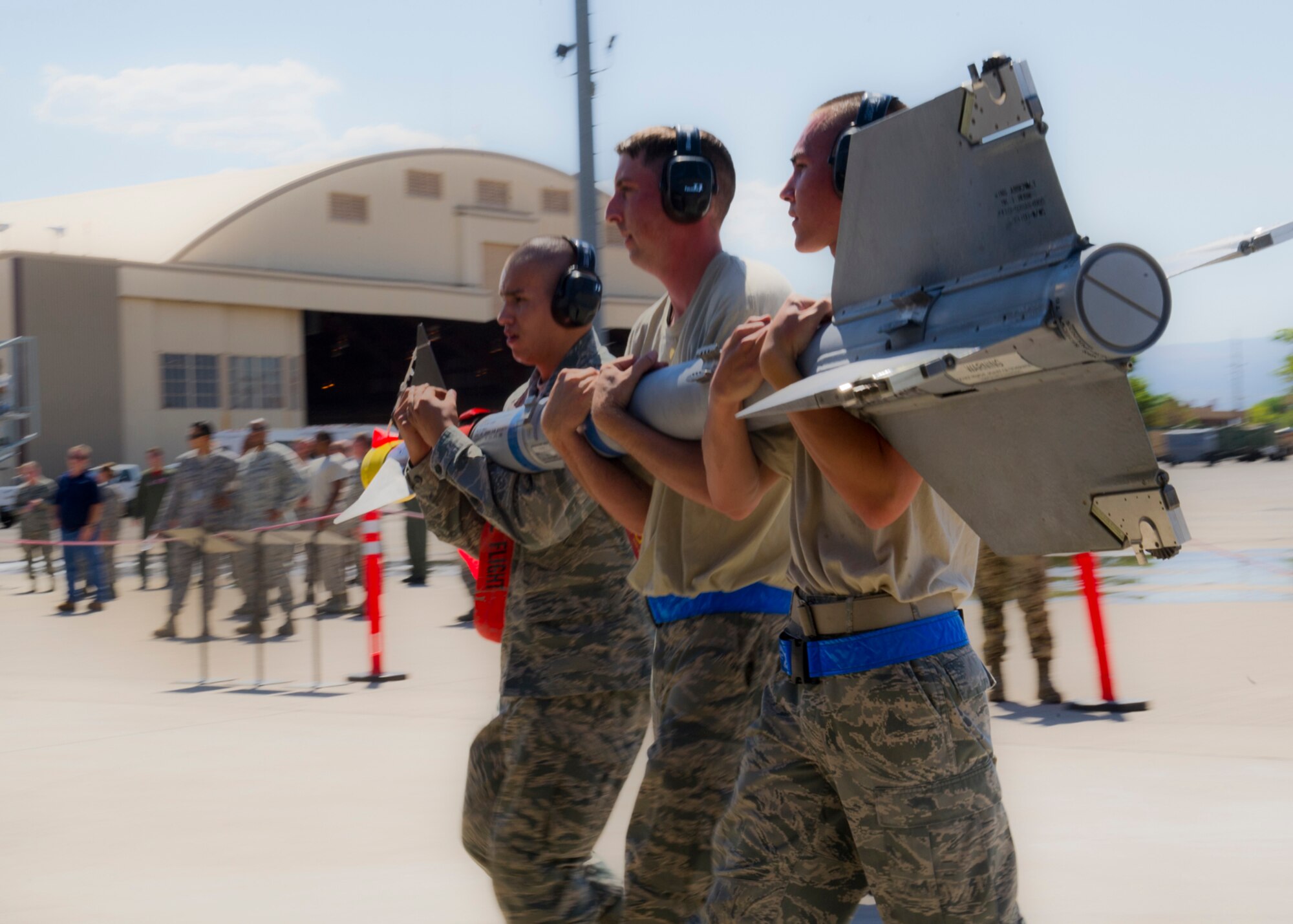 HOLLOMAN AIR FORCE BASE, N.M. -- Senior Airman Eric Bucholz, 49th Aircraft Maintenance Squadron, lifts a GBU-32 bomb with an MJ-1 Jammer during a load crew competition July 8, 2011, outside of Hangar 301. The competition tests weapons load crew’s abilities to load multiple aircraft munitions with speed and precision. This particular competition marked the first time a German Air Force load crew participated with the 49th Maintenance Squadron’s crews. (U.S. Air Force photo by Senior Airman John D. Strong II/Released)