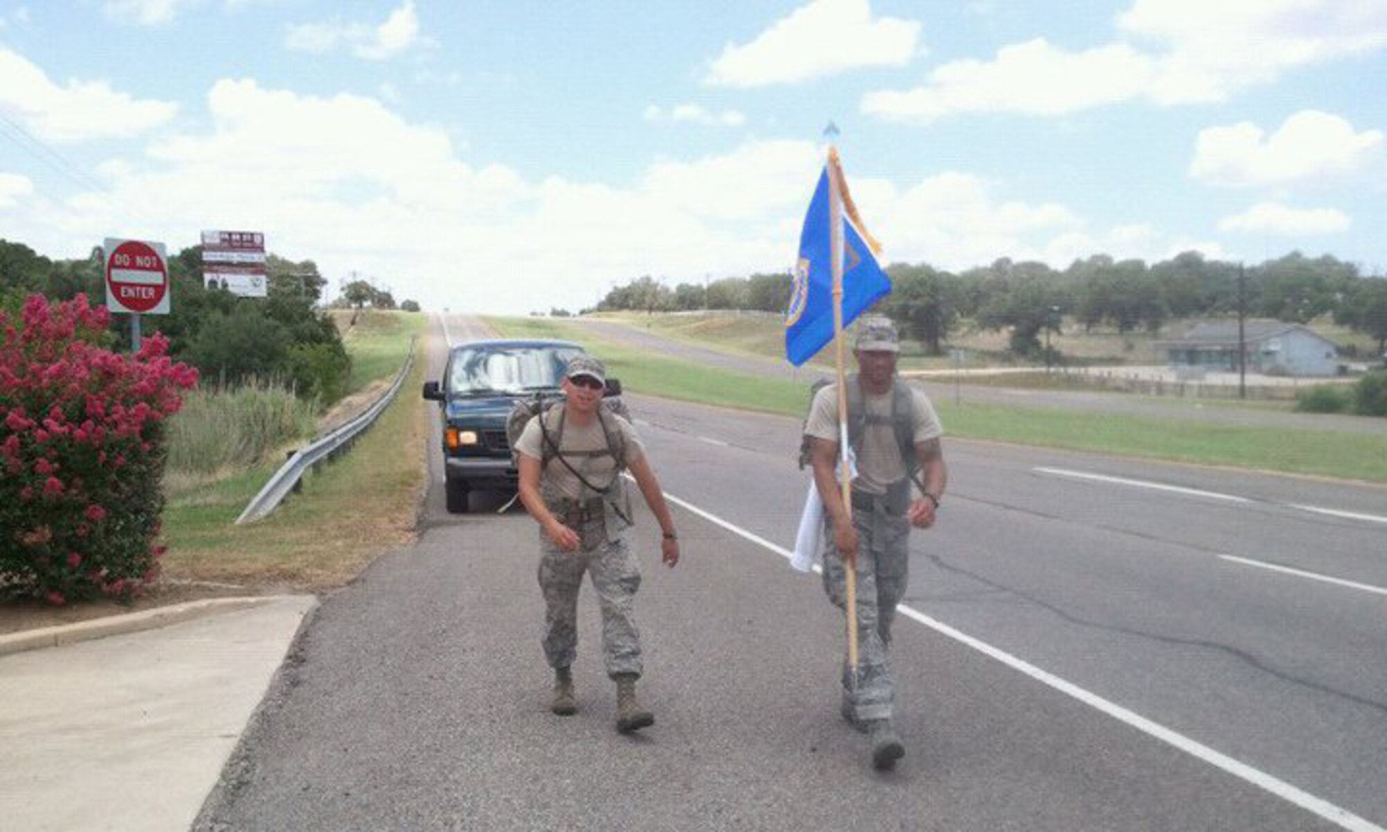 A safety vehicle trails members of the Joint Base San Antonio security forces community July 12, 2011, who are east of San Antonio as they begin the first leg of what will be a 2,181 mile trek to Ground Zero in New York City, arriving on Sept. 11.  (Courtesy photo) 