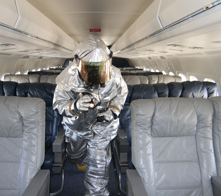 A firefighter from the 932nd Civil Engineering Squadron, responds  to a simulated fire inside the C-9C cabin.  Air Force Reserve firefighters  used two P-23 crash trucks and a rescue team to put out the aircraft "fire."  Firefighters entered the aircraft in full gear and performed checks  of  the galley, cabin and flight deck.  The 932nd Airlift Wing is the only Air Force Reserve unit that flies the C-9C.  The 932nd AW is based at Scott Air Force Base, Ill. (U.S. Air  Force photo/Tech. Sgt. Chris Parr)