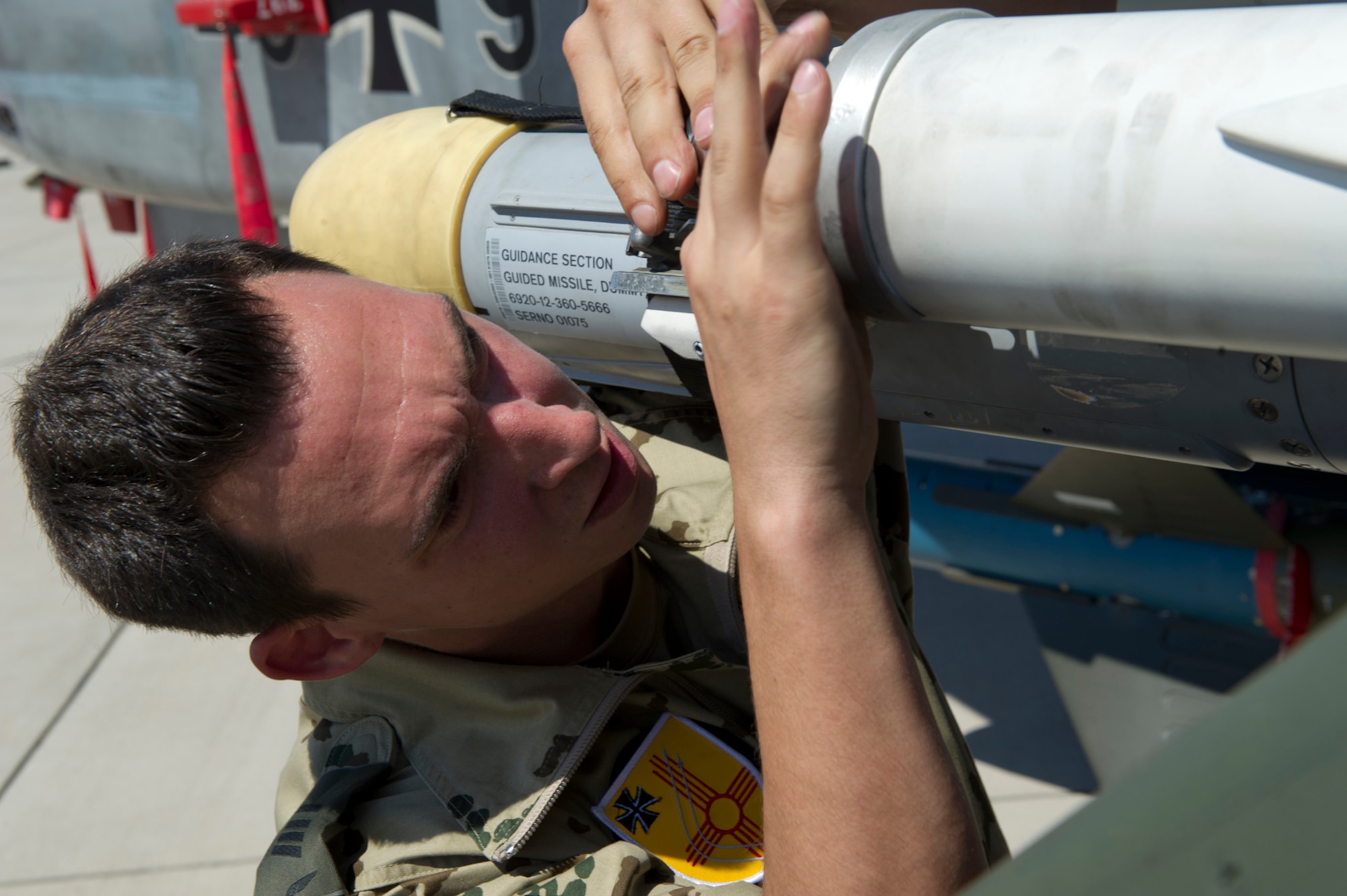 HOLLOMAN AIR FORCE BASE, N.M. -- German Air Force Senior Airman Marco Kollmer, crew chief, connects an AIM-2000 air-to-air missile July 8, 2011, during a quarterly load crew competition. The GAF crew chiefs were competing for the first time against the 49th Maintenance Group for the title of “Best Load Crew.” The competitions are held to give weapons personnel the opportunity to display their warfighting skills and unveils the best weapons load crew for a particular quarter during the year.  (U.S. Air Force photo by Airman 1st Class Joshua Turner/Released)