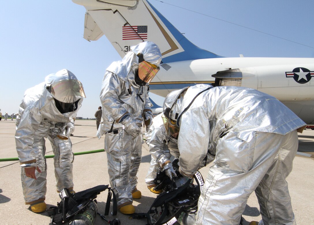 Firefighters from the 932nd Civil Engineering Squadron, prepare to go aboard the C-9C to conduct egress  training.  Firefighters entered the aircraft in full gear and put out a simulated fire inside the passenger cabin.  The exercise included using two P-23 crash trucks, a tanker and rescue crew.  Master Sgt. James Sandbothe, assistant chief of firefighting operations, said proficiency training is held at least twice a year.  The 932nd Airlift Wing is  the only Air Force Reserve unit that flies the C-9C.  (U.S. Air  Force photo/Tech. Sgt. Chris Parr)