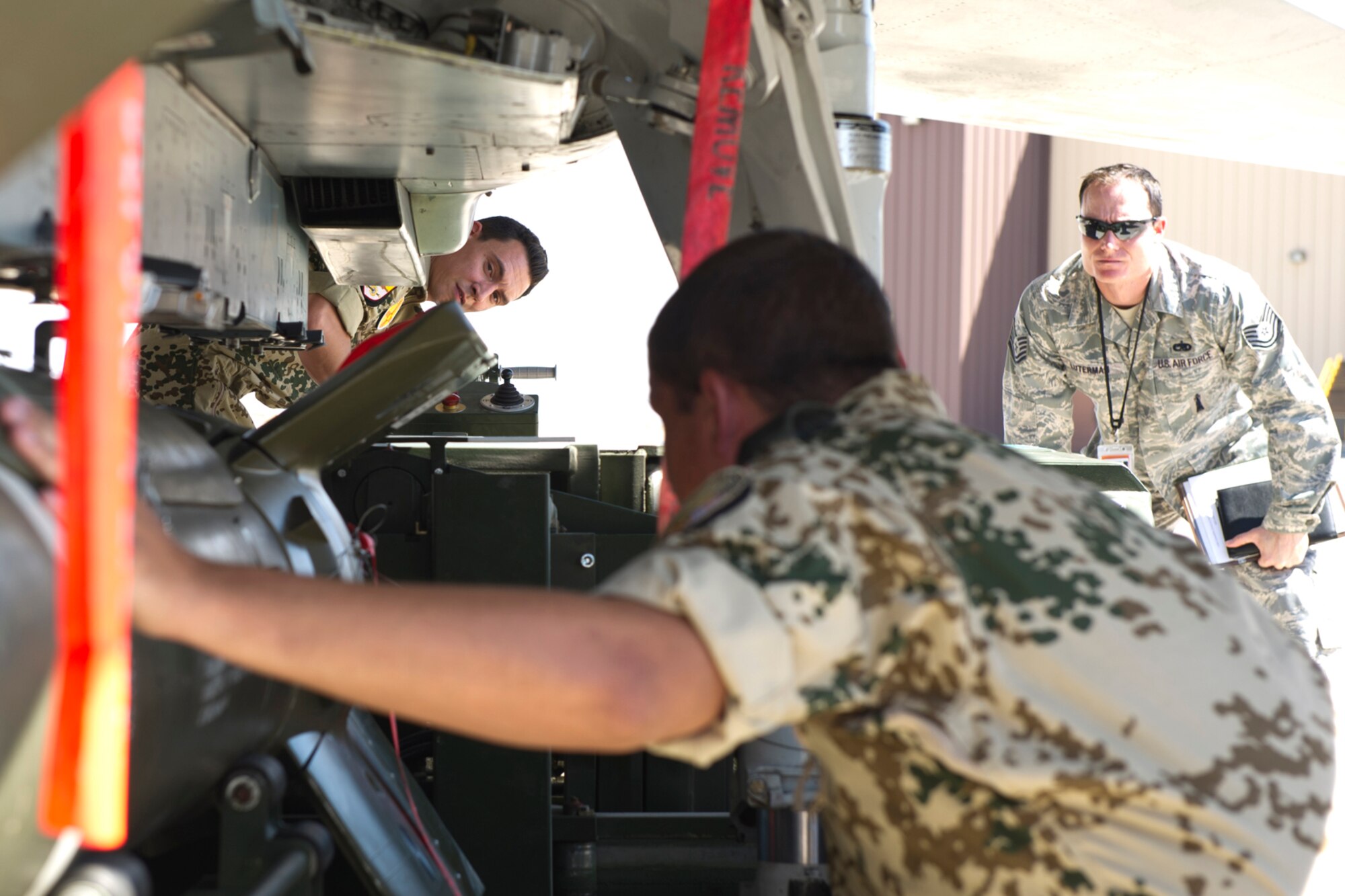 HOLLOMAN AIR FORCE BASE, N.M. -- German Air Force Senior Airman Marco Kollmer and German Air Force Tech. Sgt. Martin Wattler, both crew chiefs, align a GBU-24 laser-guided bomb under a Tornado, July 8, 2011, during a quarterly load crew competition. The GAF crew chiefs competed for the first time against the 49th Maintenance Group for the title of “Best Load Crew.” (U.S. Air Force photo by Airman 1st Class Joshua Turner/Released)