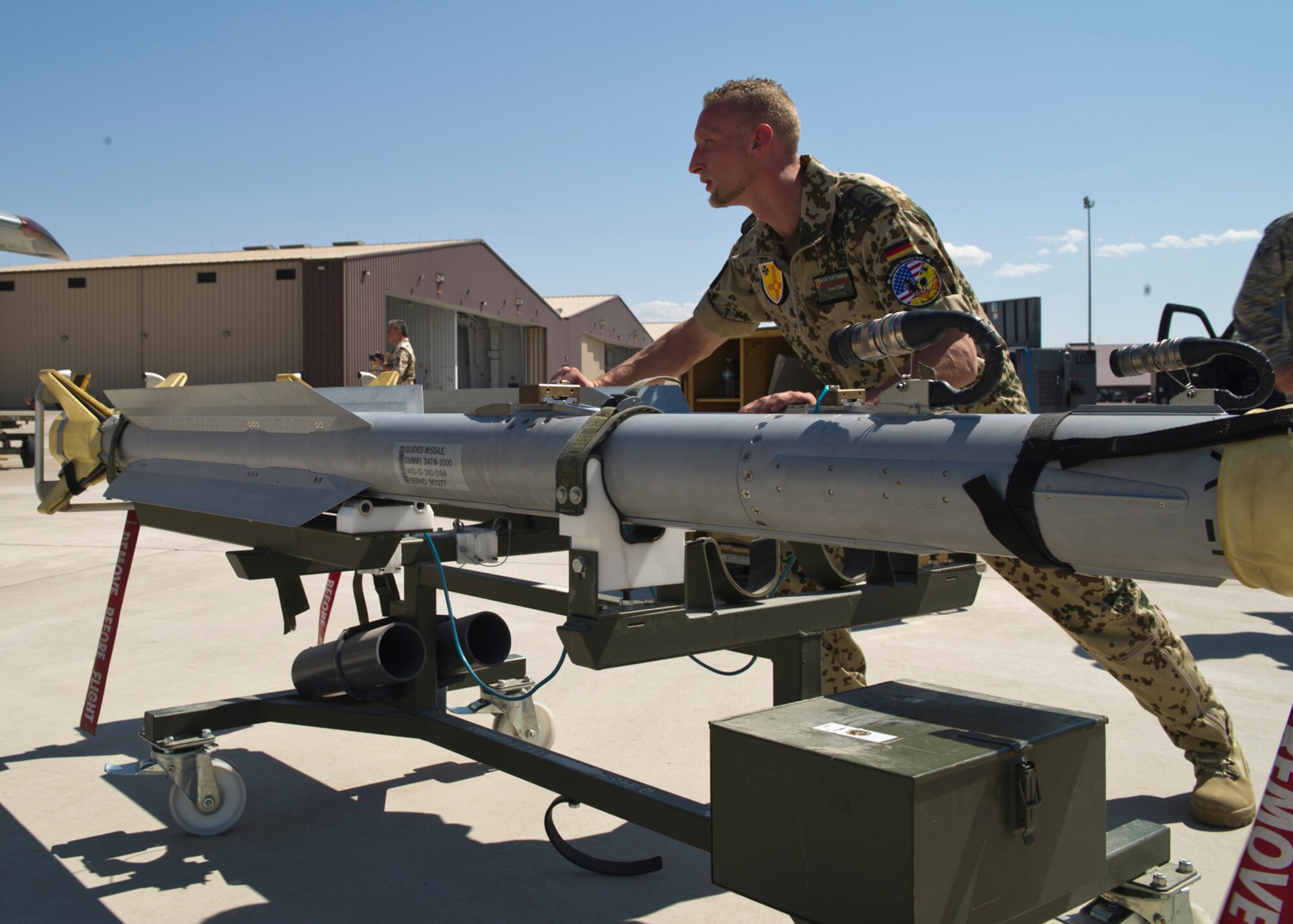 HOLLOMAN AIR FORCE BASE, N.M. -- German Air Force Tech. Sgt. Jens Feddersan, crew chief, pushes an AIM-2000 air-to-air missile toward a Tornado, July 8, 2011, during a quarterly load crew competition. During a competition, each member has a set of tasks to carry out and work in teams of three or four, depending on the aircraft. The GAF crew chiefs were competing for the first time against the 49th Maintenance Group for the title of “Best Load Crew.” (U.S. Air Force photo by Airman 1st Class Joshua Turner/Released)