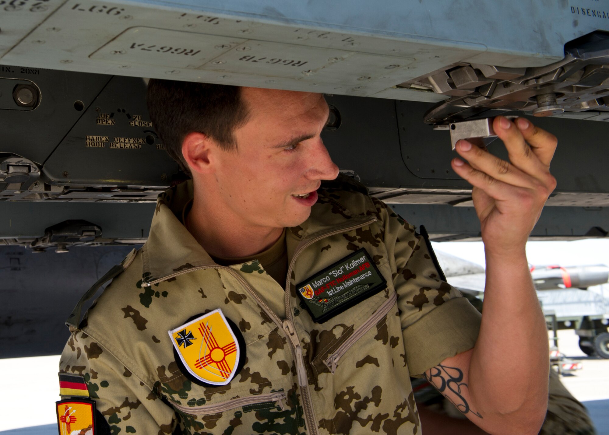 HOLLOMAN AIR FORCE BASE, N.M. -- German Air Force Senior Airman Marco Kollmer, crew chief, prepares a pylon for a GBU-24 laser-guided bomb under a Tornado, July 8, 2011, during a quarterly load crew competition. The GAF crew chiefs were competing for the first time against the 49th Maintenance Group for the title of the “Best Load Crew.” (U.S. Air Force photo by Airman 1st Class Joshua Turner/Released)
