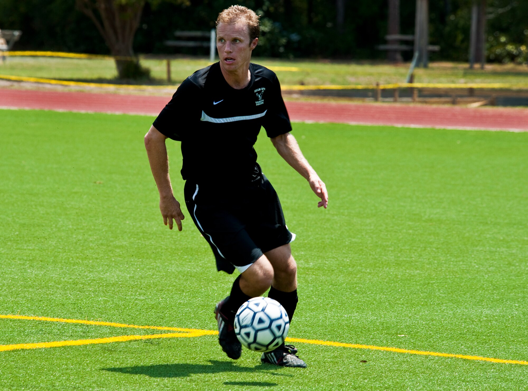 Kevin Brink looks for an open teammate during the military soccer tournament at Hurlburt Field July 9. Eglin's team defeated Patrick Air Force Base and Pensacola Naval Air Station. The games were a warm-up for the 2011 Defender’s Cup in San Antonio during Labor Day weekend. Eglin is the defending champion of the tournament. (U.S. Air Force Photo/Sachel Seabrook)