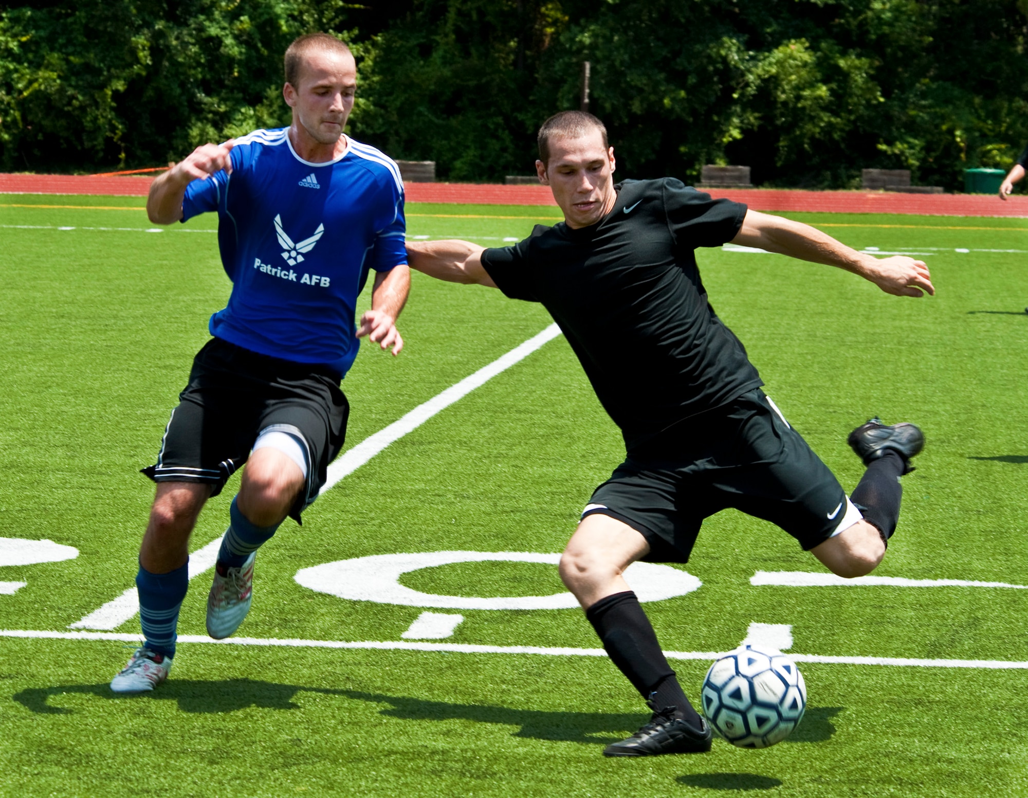 An Eglin player holds off an opponent during the military soccer tournament at Hurlburt Field July 9. Eglin's team defeated Patrick Air Force Base and Pensacola Naval Air Station. The games were a warm-up for the 2011 Defender’s Cup in San Antonio during Labor Day weekend. Eglin is the defending champion of the tournament. (U.S. Air Force Photo/Sachel Seabrook)