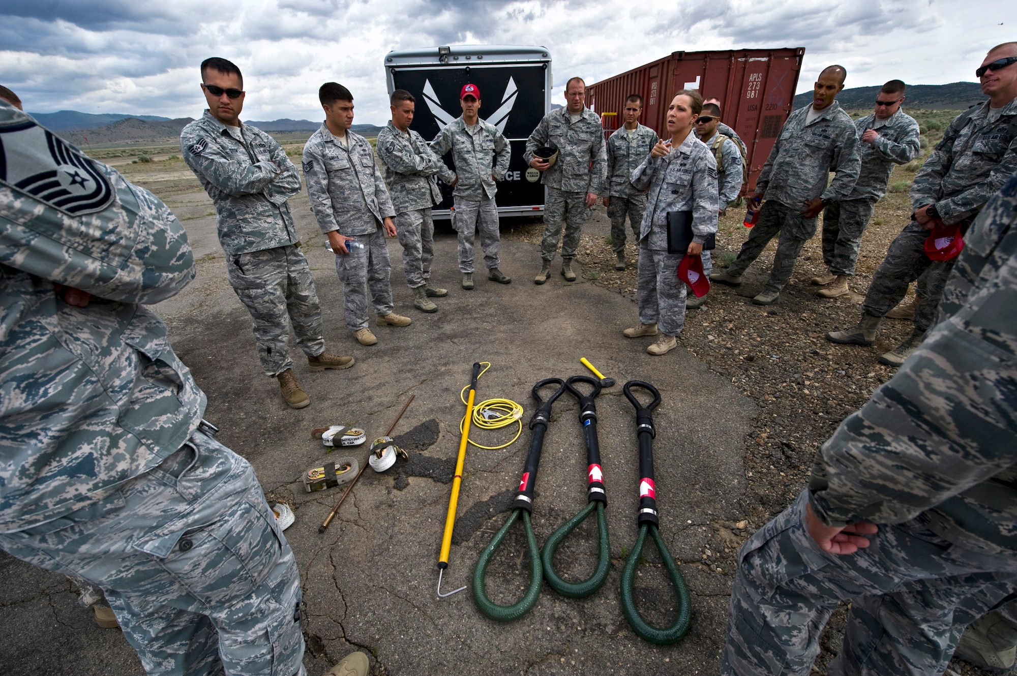 U.S. Air Force Staff Sgt. Emily Martin, 820th RED HORSE Squadron airborne flight emergency and readiness management craftsman, explains the training agenda for the sling-load exercise to other RED HORSE Airmen June 28, 2011, at the Senator Harry Reid Readiness and Training Center in Stead, Nev.  Members of the Nevada Army National Guard 1st Battalion, 189th Aviation Company  and the 820 RHS airborne flight trained together to improve their expertise in conducting air drops and sling-load operations. (U.S. Air Force photo by Senior Airman Brett Clashman/Released)
