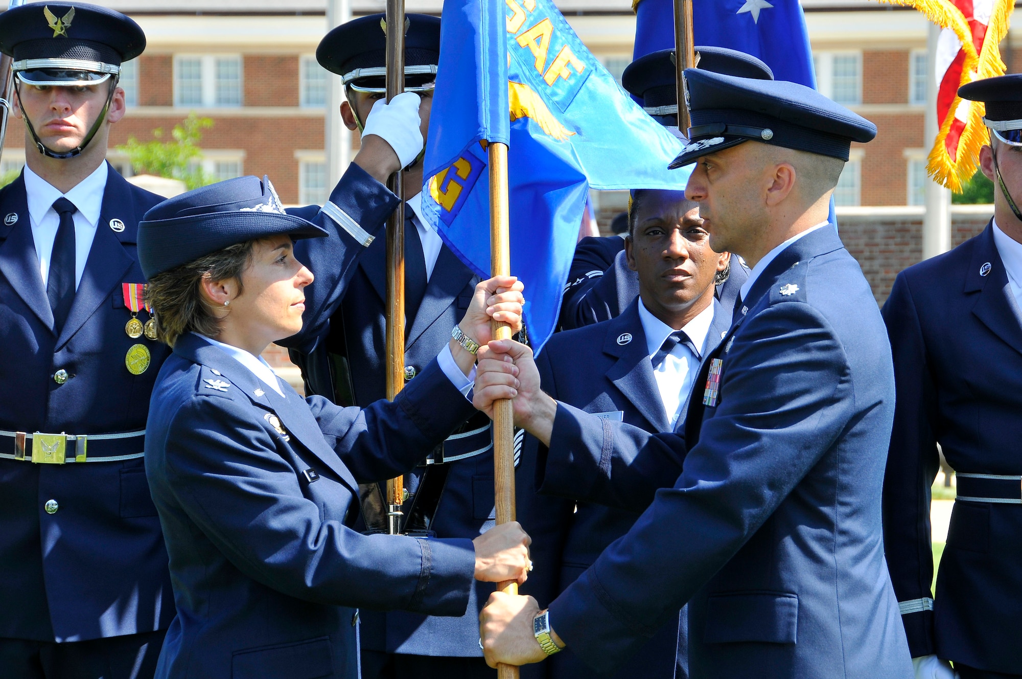 Col. Gina M. Humble, 11th Operations Group commander, passes the guidon to Lt. Col. Kenneth A. Marentette, U.S. Air Force Honor Guard commander, during the change of command ceremony July 12, at Joint Base Anacostia-Bolling, D.C. The USAF Honor Guard consists of four ceremonial flights: Colors, Bearers, Firing Party or team and Parade Flight. It is also home to the USAF Drill Team. (U.S. Air Force photo by Senior Airman Steele C. G. Britton)