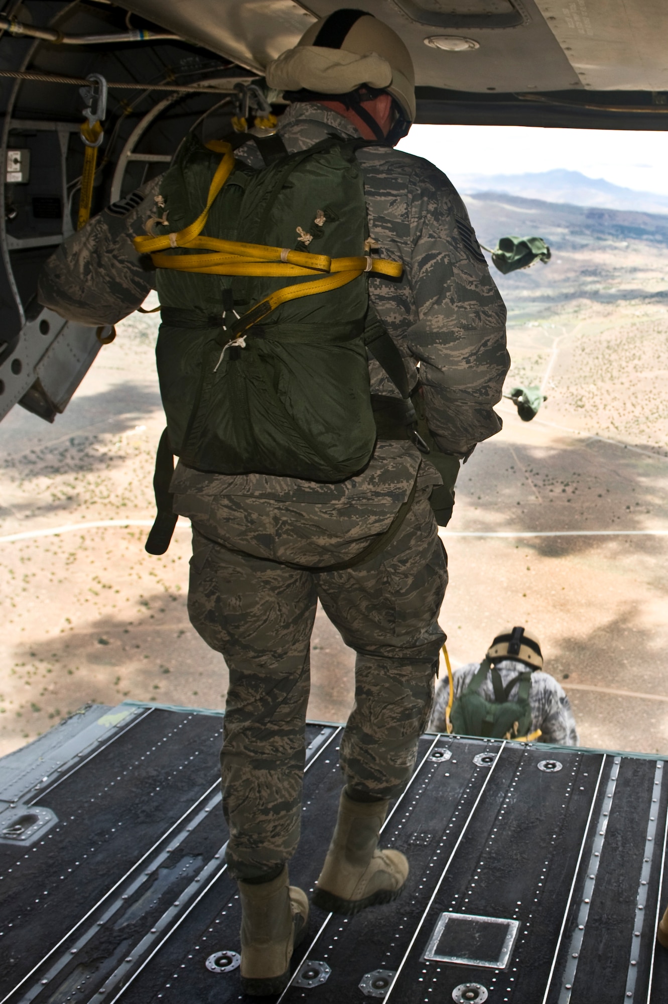U.S. Air Force jumpers from the 820th RED HORSE Squadron airborne flight execute static line jumps out of a Nevada Army National Guard CH-47 Chinook helicopter June 28, 2011, inside the Senator Harry Reid Readiness and Training Center in Stead, Nev. Members of the Nevada Army National Guard 1st Battalion, 189th Aviation Company and the 820 RHS airborne flight trained together to improve their expertise in conducting air drops and sling-load operations. (U.S. Air Force photo by Senior Airman Brett Clashman/Released) 

