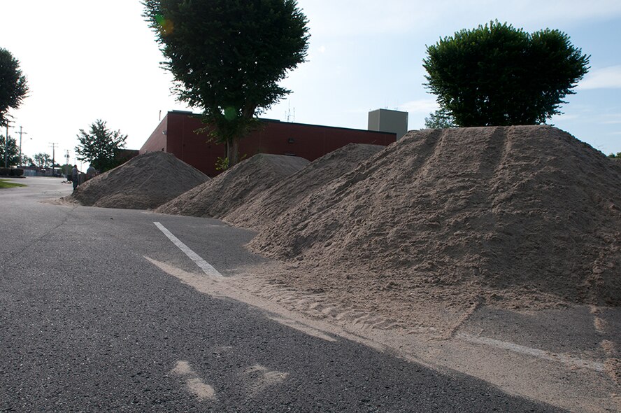 Airmen with the Missouri Air National Guard’s 139th Airlift Wing erect HESCO barriers around various buildings at Rosecrans Air National Guard Base, St. Joseph, Mo., July 12, 2011. The sand-filled barriers are being installed as a precautionary measure should the Missouri River breach the levees here. (U.S. Air Force photo by Staff Sgt. Michael Crane)