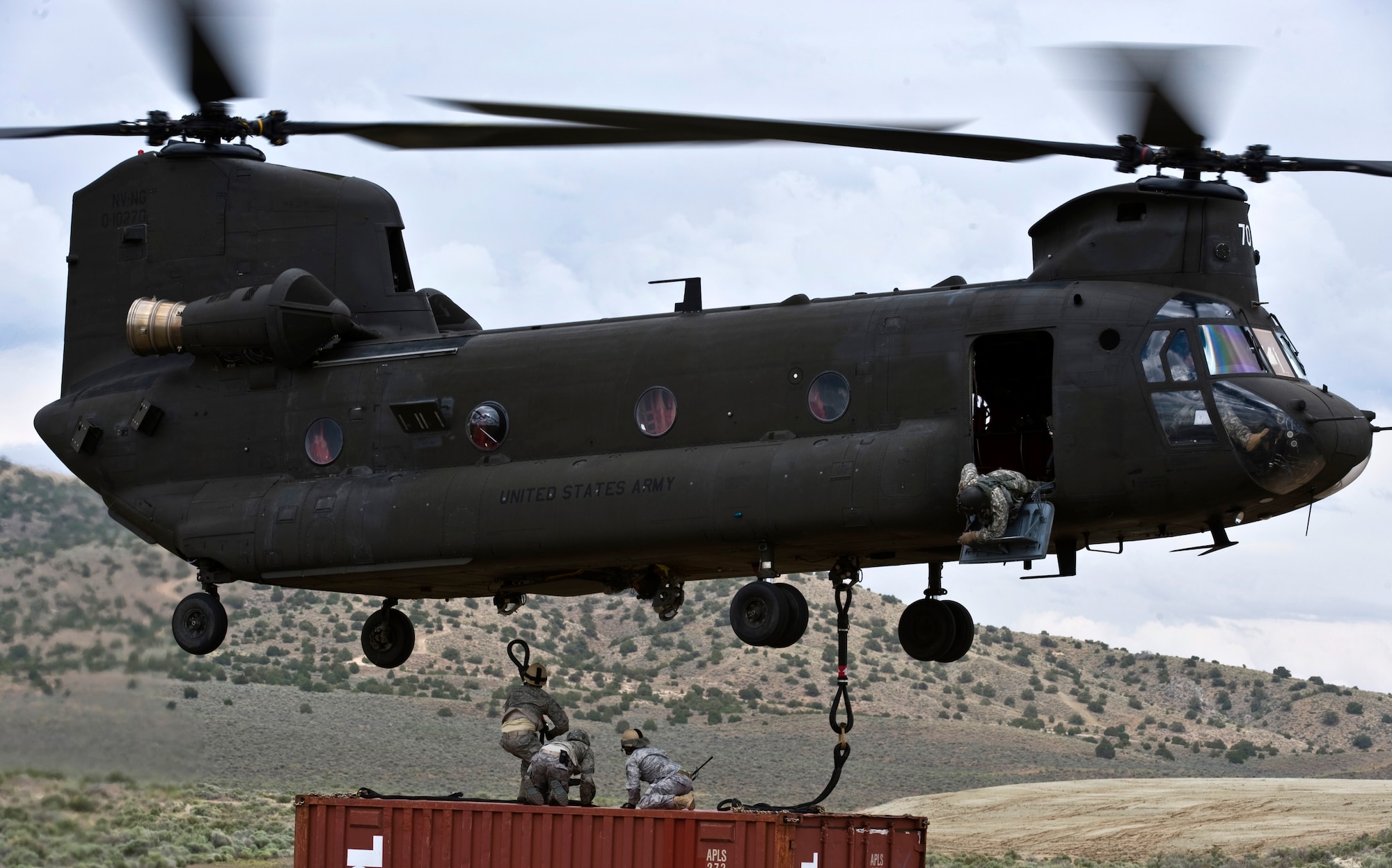 A Nevada Army National Guard CH-47 Chinook helicopter hovers as 820th RED HORSE Squadron airborne flight Airmen prepare to rig a storage container June 28, 2011, at the Senator Harry Reid Readiness and Training Center in Stead, Nev.  Members of the Nevada Army National Guard 1st Battalion, 189th Aviation Company and the 820 RHS airborne flight trained together to improve their expertise in conducting air drops and sling-load operations. (U.S. Air Force photo by Senior Airman Brett Clashman/Released)


