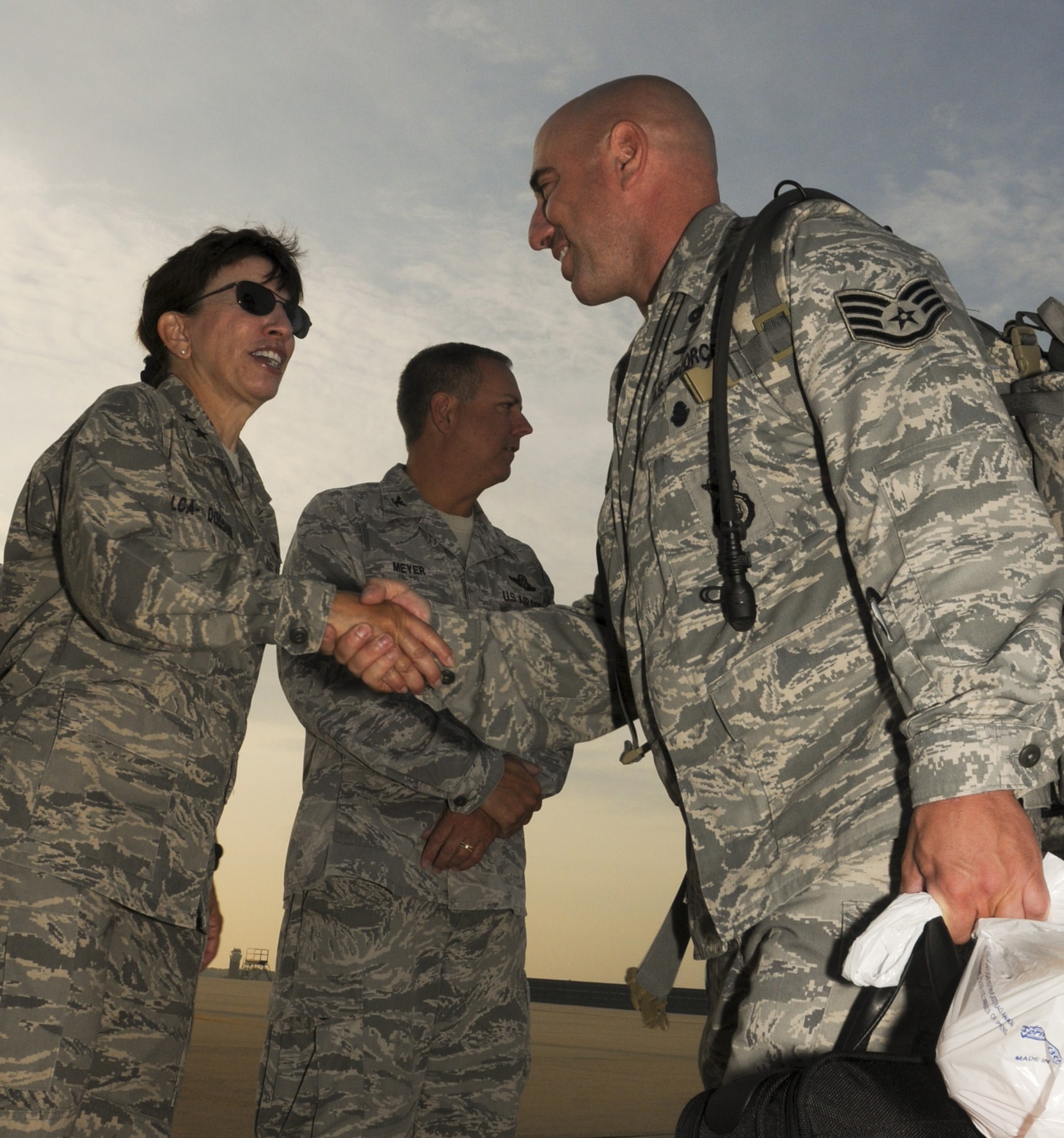 U.S. Air Force Maj. Gen. Maria Falca-Dodson, left, commander New Jersey Air National Guard, wishes good luck to Staff Sgt. Jonathan Arochas, a member of the 108th Security Forces Squadron, before he boards a KC-135R Stratotanker at Joint Base McGuire-Dix-Lakehurst on July 12, 2011. Arochas, along with about 30 other security forces members, have deployed to Southwest Asia in support of Operation New Dawn where they will be responsible for maintaining security at the air base. (U.S. Air Force photo/Airman Kellyann Novak)