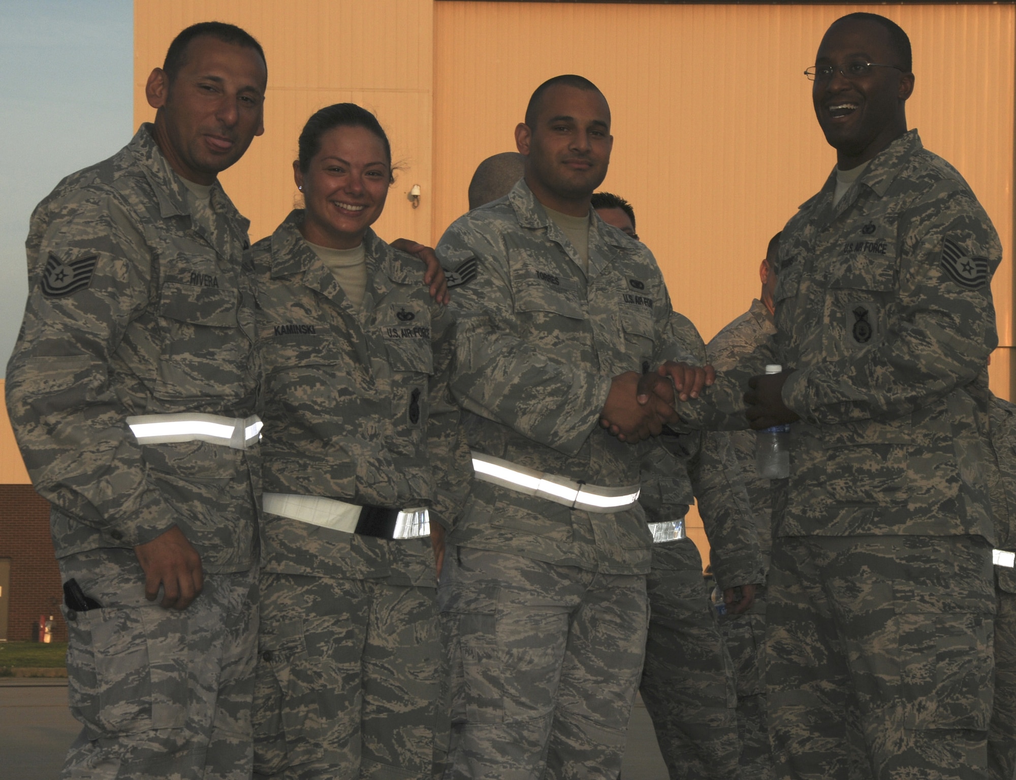 Members of the 108th Security Forces Squadron pose for a group photo at the flight line while they wait to board a KC-135R Stratotanker on Joint Base McGuire-Dix-Lakehurst on July 12, 2011. Approximately 30 security forces members deployed to Southwest Asia in support of Operation New Dawn where they will be responsible for maintaining security at the air base. (U.S. Air Force photo/Airman Kellyann Novak)
