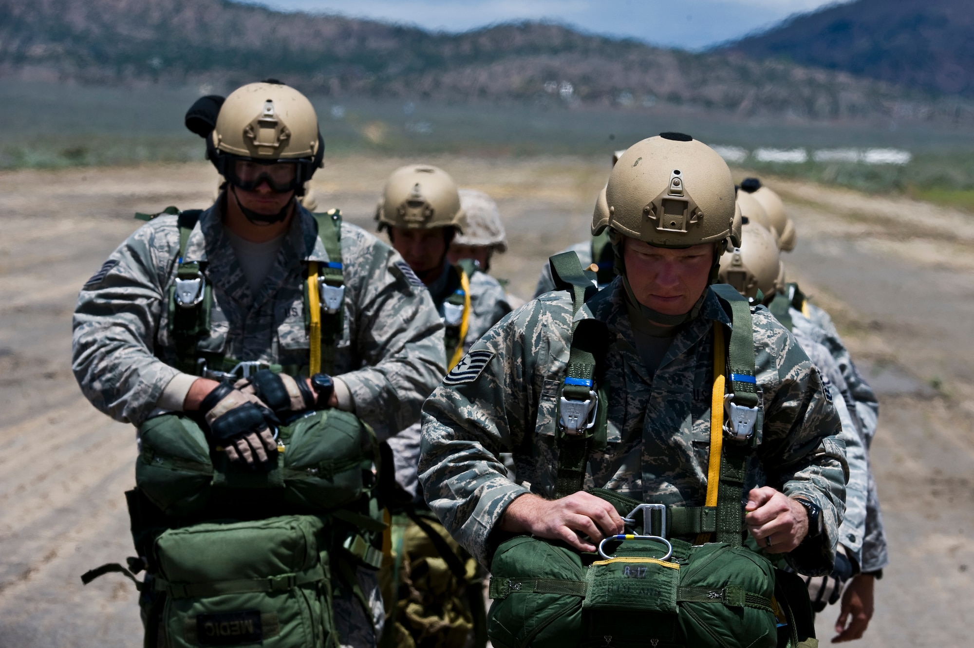 U.S. Air Force Tech. Sgt. Mitchell Romag, right, 820th RED HORSE Squadron airborne flight pavement and equipment operator craftsman, leads his jump unit prior to boarding a Nevada Army National Guard CH-47 Chinook helicopter June 28, 2011, at the Senator Harry Reid Readiness and Training Center in Stead, Nev. Members of the Nevada Army National Guard 1st Battalion, 189th Aviation Company and the 820 RHS airborne flight trained together to improve their expertise in conducting air drops and sling-load operations. (U.S. Air Force photo by Senior Airman Brett Clashman/Released)
