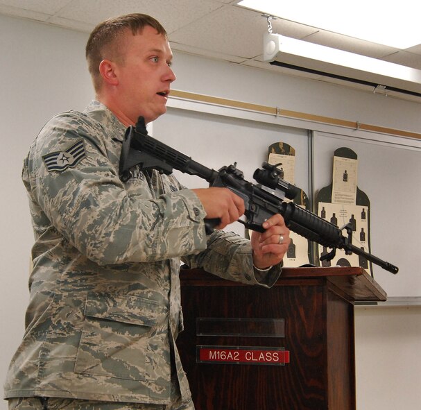 Staff Sgt. Sean Walker, 94th Security Forces Squadron, provides classroom instruction on the M-4 carbine for Security Forces Airmen at Dobbins Air Reserve Base during the monthly Unit Training Assembly, July 9.  94th Security Forces Combat Arms Training and Maintenance instructors conduct the training with several hours of classroom and firing range instruction ending with a qualification course of fire.  (U.S. Air Force photo/ Brad Fallin)