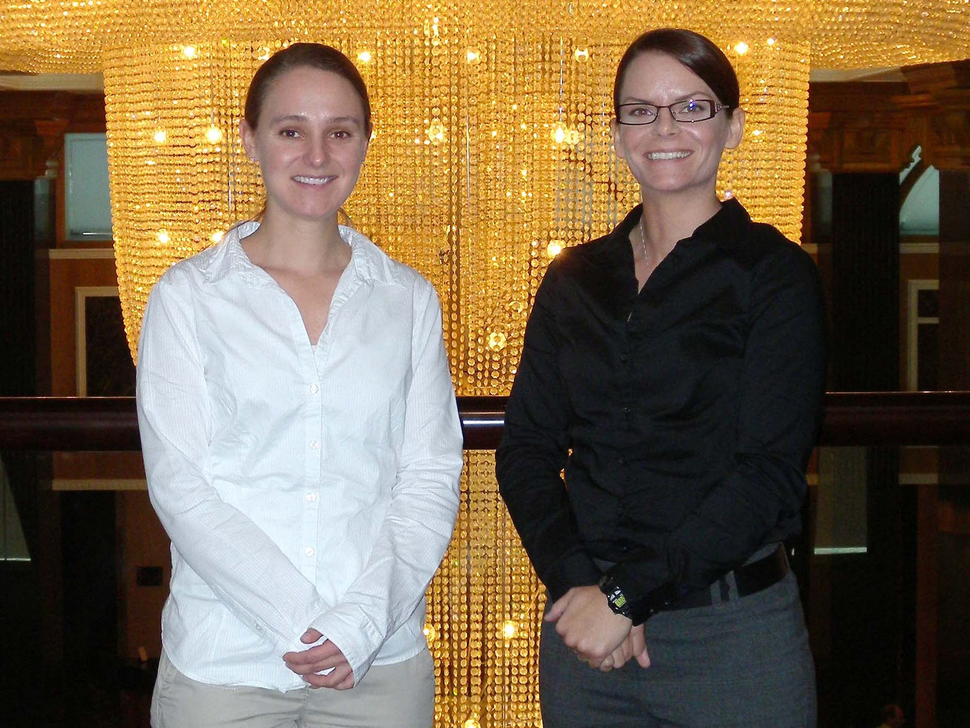 Air Force Office of Special Investigations Special Agents Megan Rauch and Sue Lantrip stop for a photo after a conference held in Southwest Asia. SA Rauch and SA Lantrip were among seven members that attended the conference which informed government and civilian contractors about their jobs as International Contract Corruption Task Force members. (U.S. Air Force Photo by Staff Sgt. Anthony Graham)