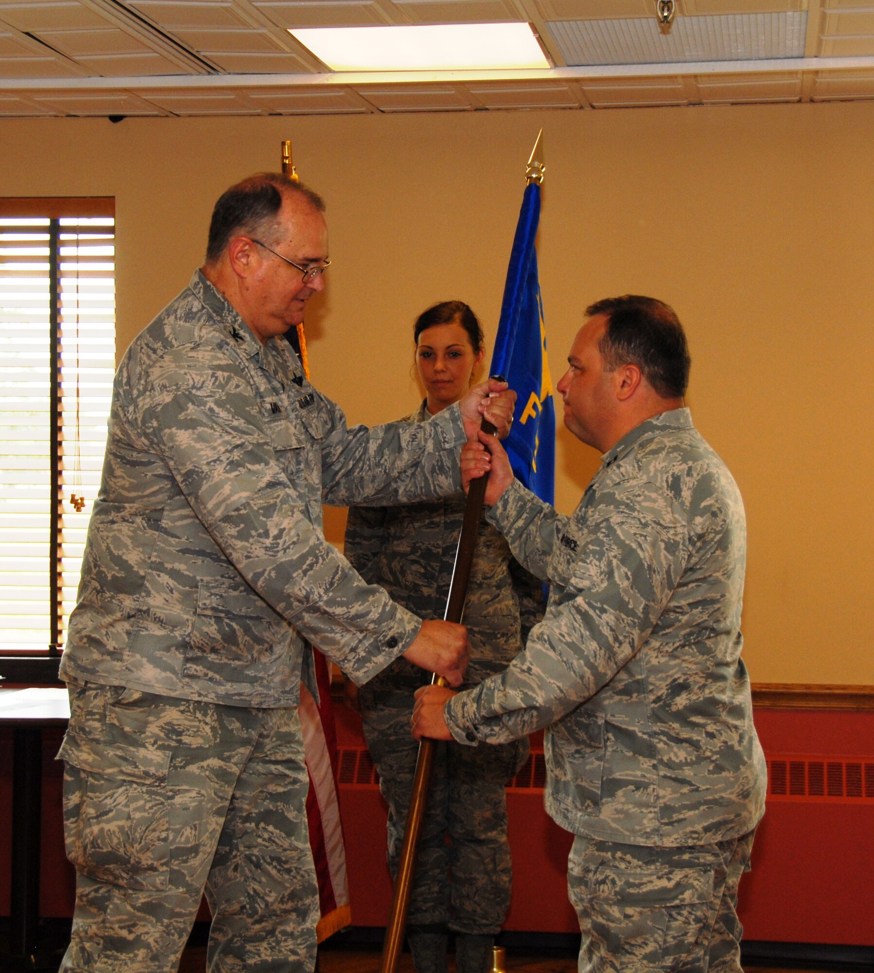 Captain Bryan Dalporto (on right) assumed command of the 107th Airlift Wing's Force Support Squadron in a ceremony recently held here. The captain previously held the position as the 107 AW Services Squadron commander and replaces outgoing Commander Lt. Col. Linda Blaszak. The captain is now responsible for more than 100 Airmen. Passing the FSS Guidon is the 107th Mission Support Commander Col. Timothy Vaughan. (U.S. Air Force photo/Tech. Sgt. Justin Huett)