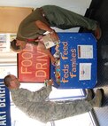 LAUGHLIN AIR FORCE BASE, Texas-- Chaplain (Maj.) Dwayne Keener, 47th Flying Training Wing chaplain, and Ruben Gomez, Laughlin’s commissary manager, sort through donations for the Feds Feed Families campaign. The food drive provides groceries and supplies for needy families in the local community. (U.S. Air Force photo by Laura Salazar)