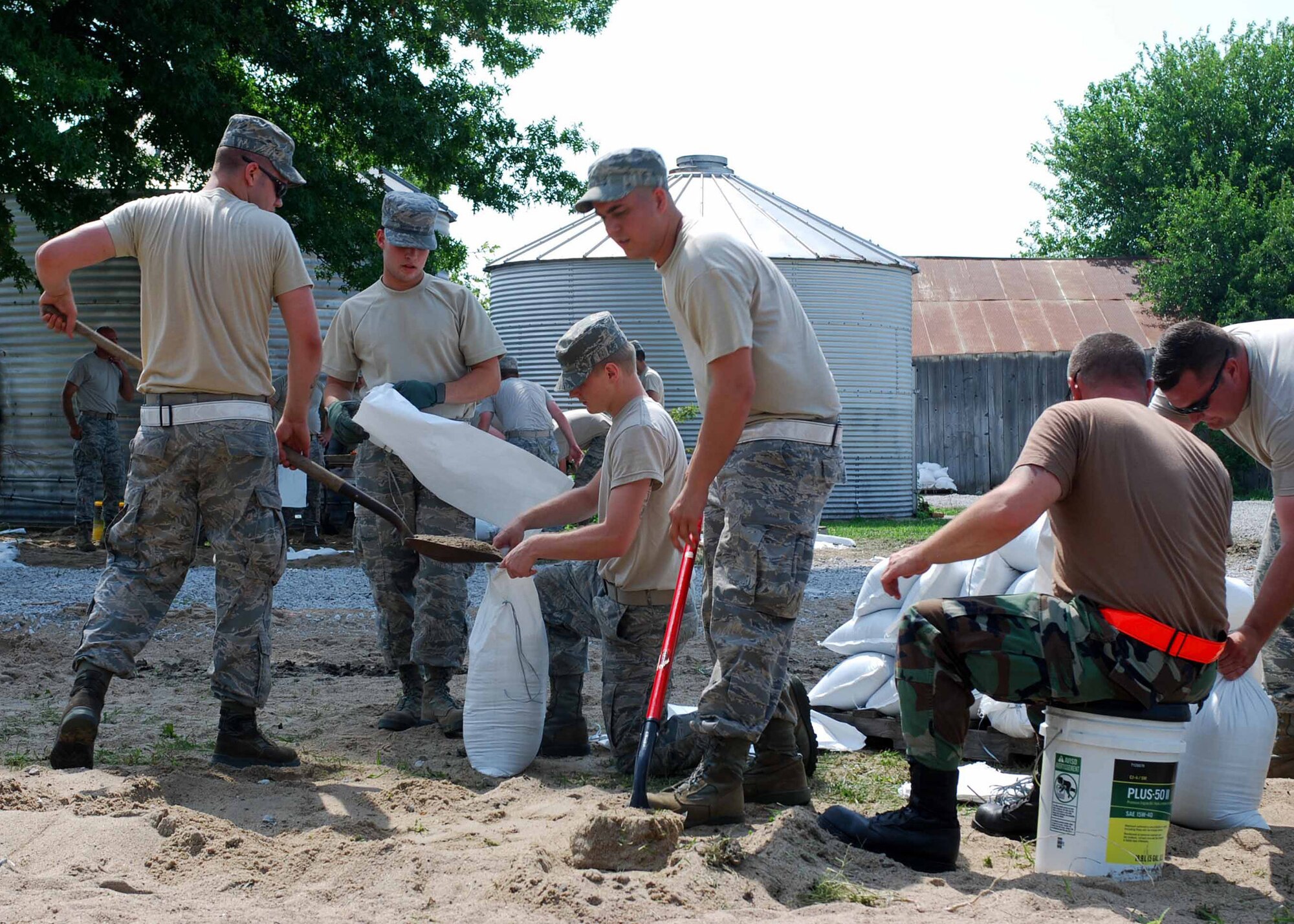 Flood missions continued throughout Carroll County as members of the Missouri Army National Guard and Missouri Air National Guard joined forces July 9 to continue sandbagging at Belcher Lozier levee and Miles Point levee. Residents were also in attendance to help. Troops at hand included the 1-129th Field Artillery Regiment, the 220th Engineer Company, the 880th Engineer Team, and the 131st Bomb Wing Aircraft Maintenance Squadron.  (Photo by Spc. Jacqueline Courtney)