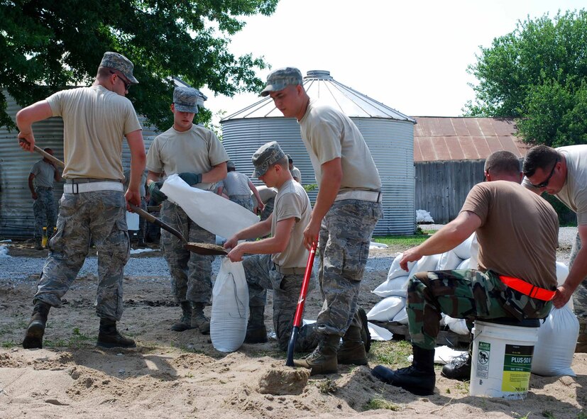 Flood missions continued throughout Carroll County as members of the Missouri Army National Guard and Missouri Air National Guard joined forces July 9 to continue sandbagging at Belcher Lozier levee and Miles Point levee. Residents were also in attendance to help. Troops at hand included the 1-129th Field Artillery Regiment, the 220th Engineer Company, the 880th Engineer Team, and the 131st Bomb Wing Aircraft Maintenance Squadron.  (Photo by Spc. Jacqueline Courtney)