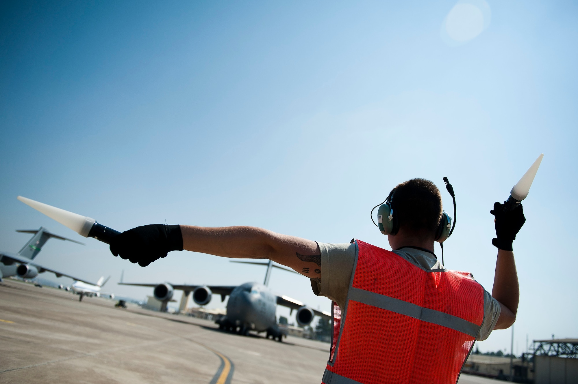 Senior Airman Timothy Baker, 728th Air Mobility Squadron Maintenance Flight, marshals a C-17 Globemaster III aircraft July 11, 2011, at Incirlik Air Base, Turkey. The maintenance flight provides maintenance and supply support for Air Mobility Command military and commercial aircraft missions. (U.S. Air Force photo by Tech. Sgt. Michael B. Keller/Released)