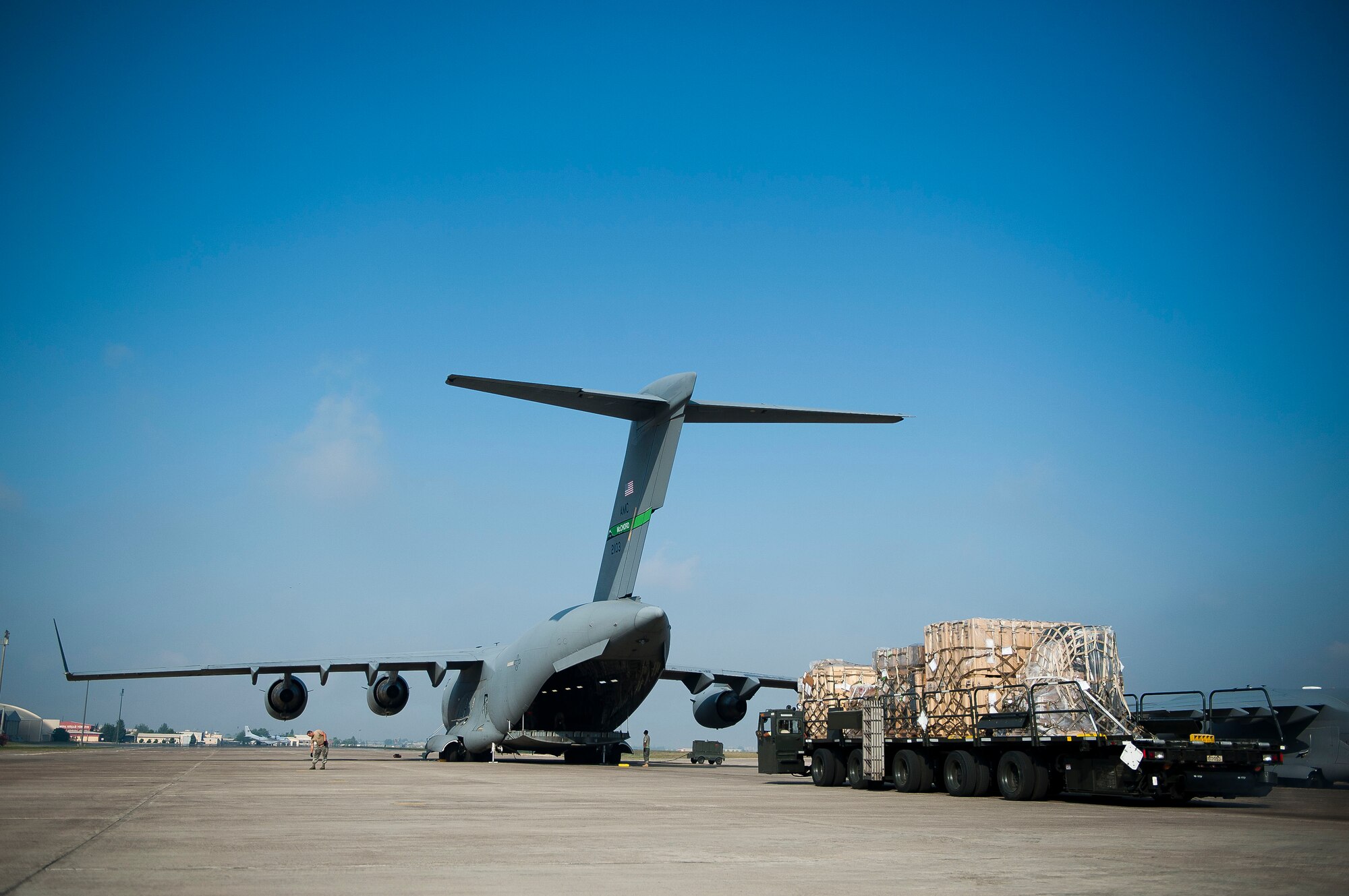 Airmen from the 728th Air Mobility Squadron Aerial Port Flight load cargo onto a C-17 Globemaster III aircraft July 11, 2011, at Incirlik Air Base, Turkey. The aerial port flight is responsible for transportation-related functions including the movement of freight bound for Europe, Africa, and Southwest and Central Asia. (U.S. Air Force photo by Tech. Sgt. Michael B. Keller/Released)