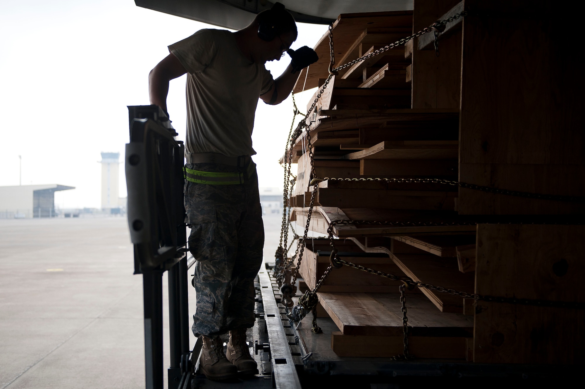 Staff Sgt. Nicolas Pantoja, 728th Air Mobility Squadron Aerial Port Flight, wipes away sweat while loading cargo onto a C-17 Globemaster III aircraft July 11, 2011, at Incirlik Air Base, Turkey. The aerial port flight is responsible for transportation-related functions including the movement of freight bound for Europe, Africa, and Southwest and Central Asia. (U.S. Air Force photo by Tech. Sgt. Michael B. Keller/Released)