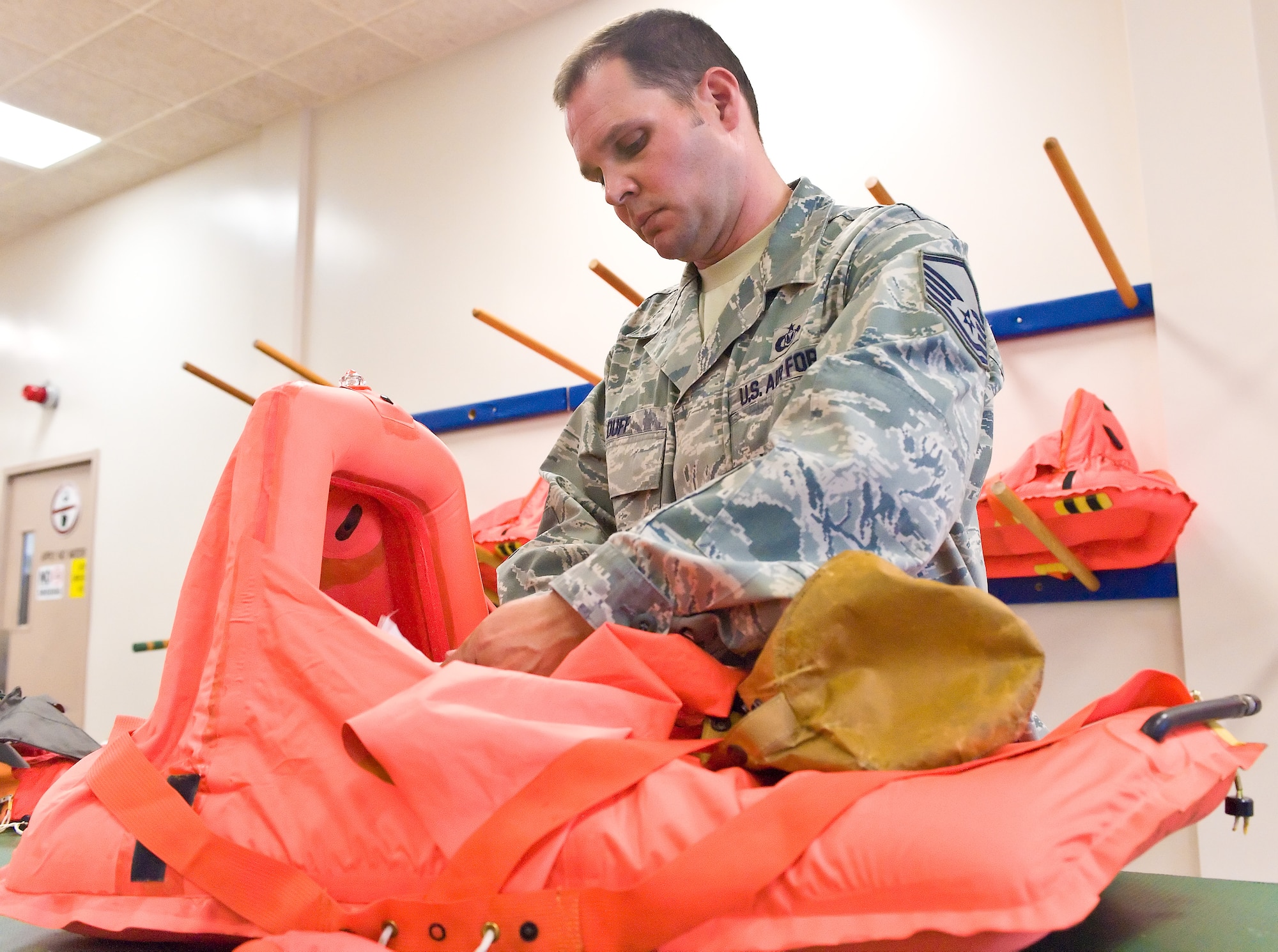 Master Sgt. Joseph Duff, 436th Operations Support Squadron Aircrew Flight Equipment quality assurance chief, inspects an infant raft July 7, 2011 at Dover Air Force Base, Del. Every C-5 Galaxy at Dover AFB is required to have at least five infant raft’s aboard at all times. (U.S. Air Force photo by Roland Balik)