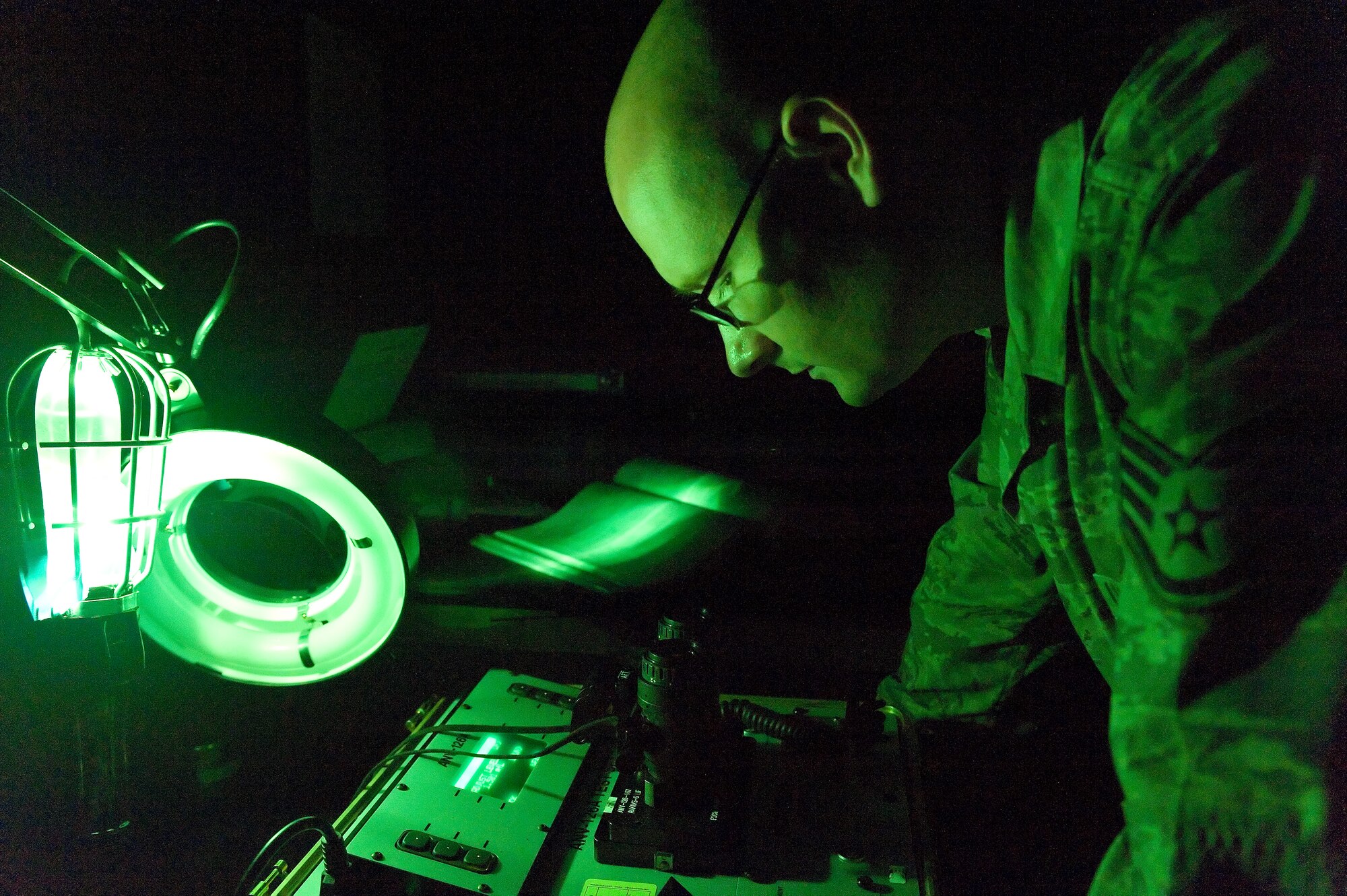 Staff Sgt. Jerry Baker, 436th Operations Support Squadron Aircrew Flight Equipment craftsman, examines a pair of night vision goggles July 7, 2011 at Dover Air Force Base, Del. Night vision goggles must be inspected for defects every six months.(U.S. Air Force photo by Roland Balik)
