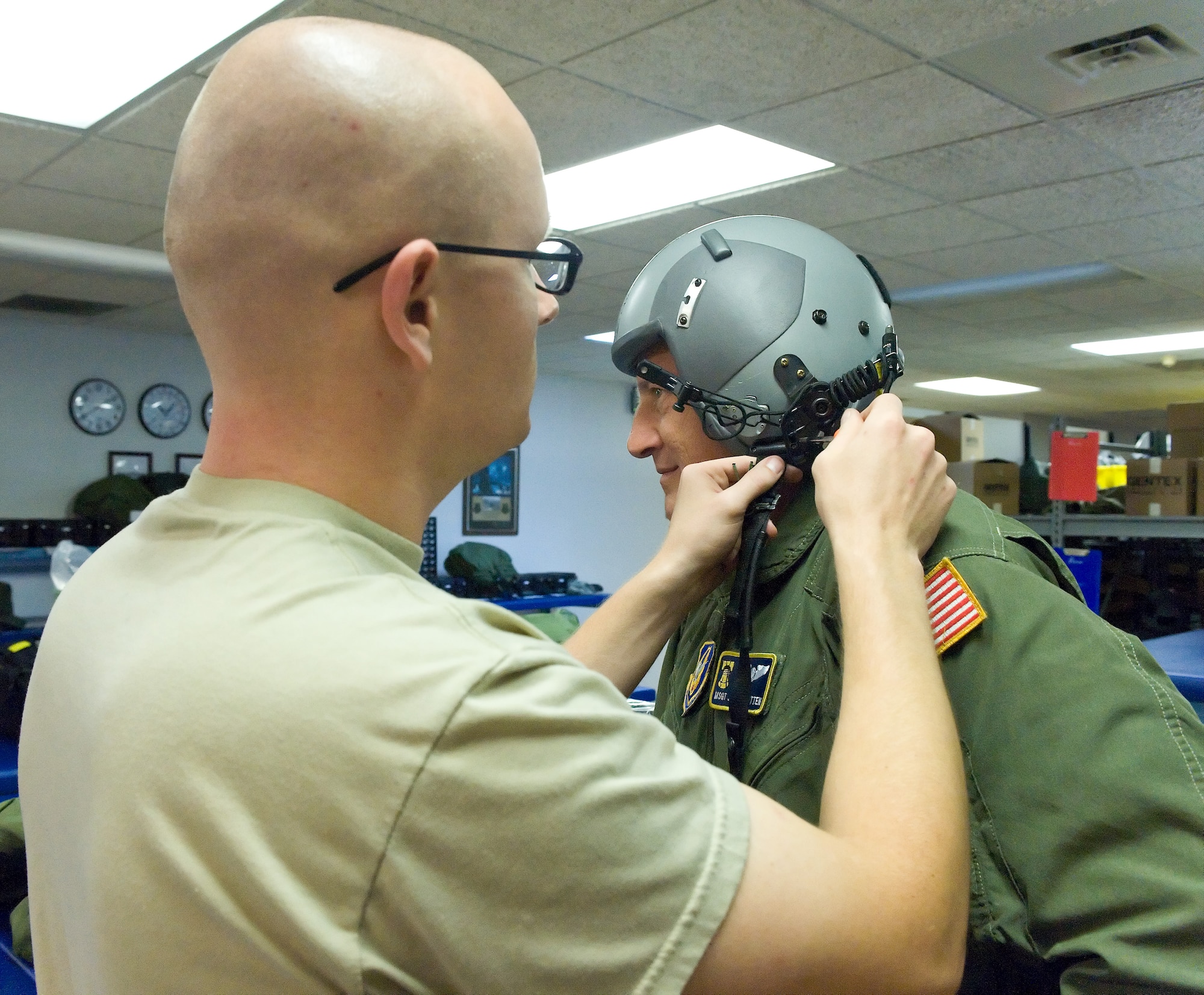 Staff Sgt. Jerry Baker (left), 436th Operations Support Squadron Aircrew Flight Equipment craftsman, fits a helmet on Master Sgt. Jeff Wooten, 512th Airlift Control Flight contingency response element loadmaster, July 7, 2011 at Dover Air Force Base, Del. The helmets worn by aircrew have to be inspected for malfunctions every 90 days. (U.S. Air Force photo by Roland Balik)