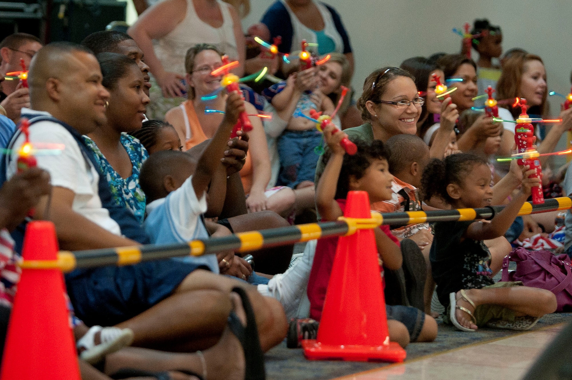Team Incirlik parents and children watch as Sesame Street characters perform at the Sesame Street/USO Experience July 11, 2011, at the Club Complex Ballroom at Incirlik Air Base, Turkey. The performance was part of a tour to U.S. military bases worldwide geared specifically toward helping children of military members deal with the stresses of deployment. (U.S. Air Force photo by Airman 1st Class Clayton Lenhardt/Released)