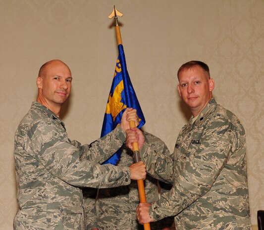 Lt. Col. Aaron Altwies accepts the 628th Civil Engineer Squadron guidon from Col. Justin Davey during the 628 CES Change of Command July 8 at Joint Base Charleston, S.C. Altwies is the new 628 CES commander and Davey is the 628th Mission Support Group commander. (U.S. Air Force photo/Tech. Sgt. Chrissy Best)