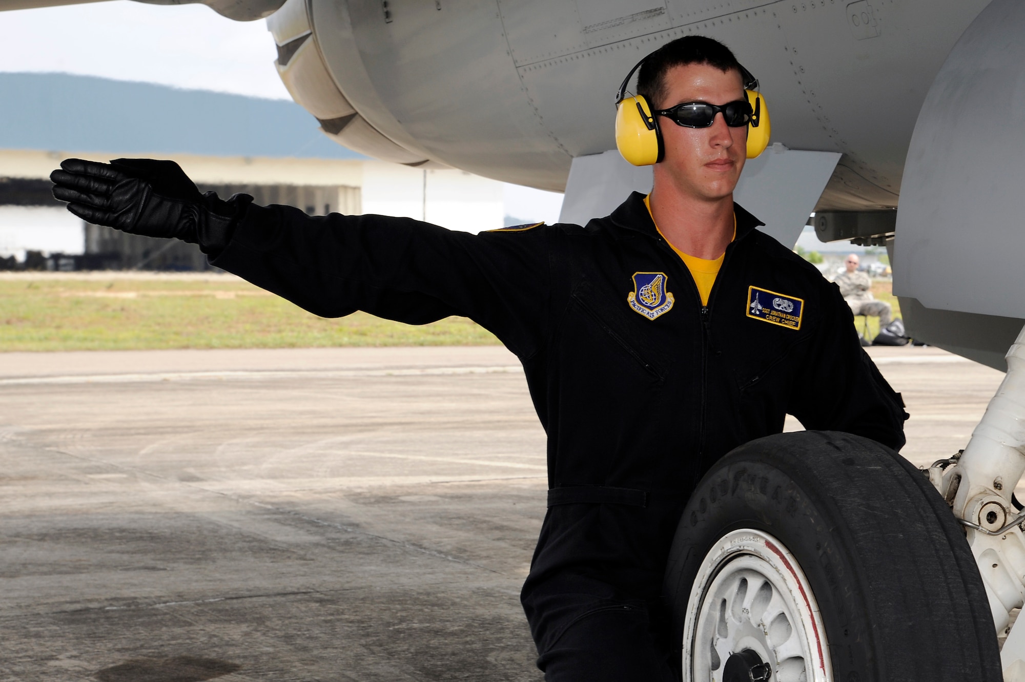Brunei Darussalam -- Staff Sgt. Jonathan Crocker, Pacific Air Forces Demonstration Team member, uses a hand signal to relay information to the crew chief during an F-16 Fighting Falcon demonstration at the 3rd Biennial Brunei Darussalam International Defense Exhibition July 8. BRIDEX provided a platform for leading manufacturers, suppliers and decision makers to deliberate on military solutions and showcase new technologies. (U.S. Air Force photo/Staff Sgt. Marie Brown/Released)