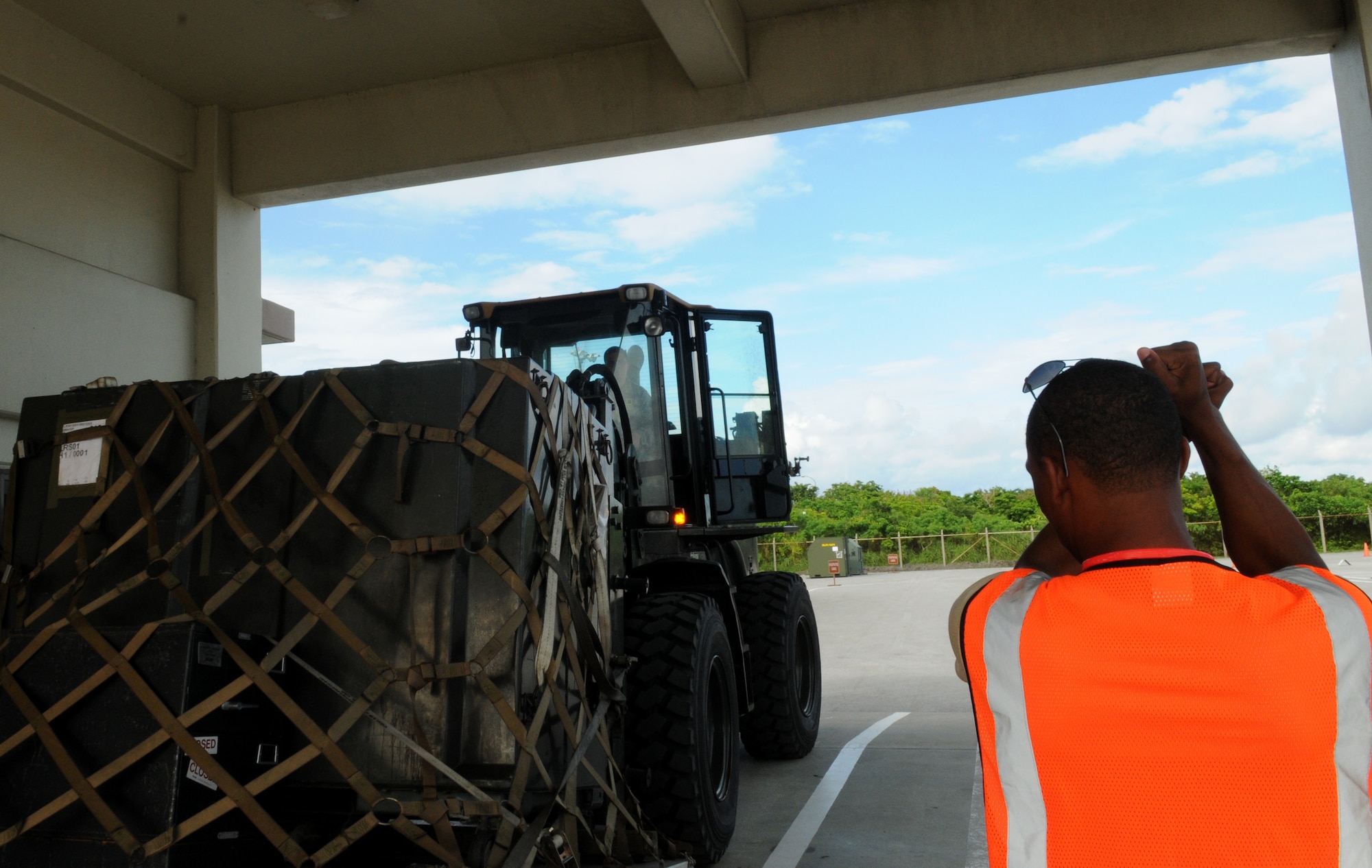 Airman 1st Class Tony Mathis, 18th Logistics Readiness Squadron vehicle mechanic, directs a forklift driver July 12 during Beverly High 11-5, a Local Operational Readiness Exercise July at Kadena Air Base, Japan. The LORE is an exercise that almost all Airmen at Kadena participate in to hone skills and keep them sharp in case of real-world emergencies. (U.S. Air Force photo/Airman 1st Class Jarvie Z. Wallace)
