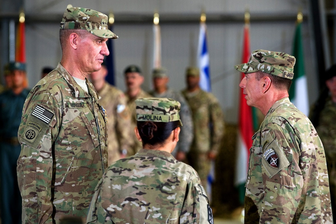 U.S. Army Lt. Gen. David M. Rodriguez, left, commander of International Security Assistance Force Joint Command, and U.S. Army Gen. David H. Petraeus, commander of U.S. and international forces in Afghanistan, talk during the change-of-command ceremony in Kabul, Afghanistan, July 11, 2011.