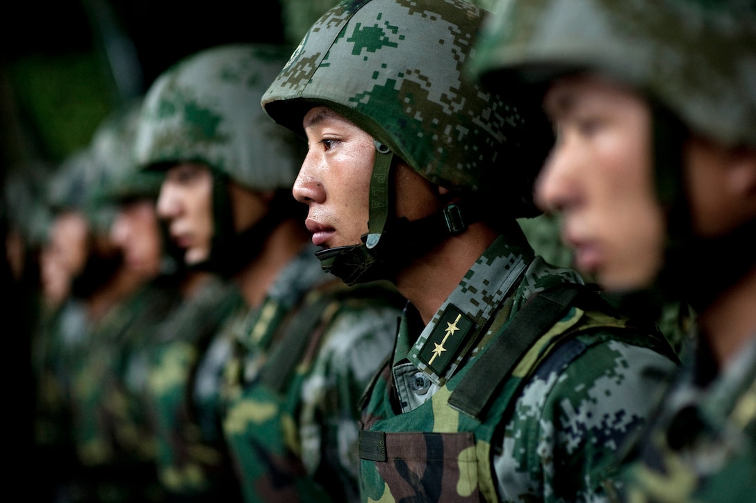 Soldiers assigned to the Chinese People's Liberation Army 1st Amphibious Mechanized Infantry Division prepare to demonstration of their capablities to U.S. Navy Adm. Mike Mullen, chairman of the Joint Chiefs of Staff, during his visit to the unit in China, July 12, 2011.