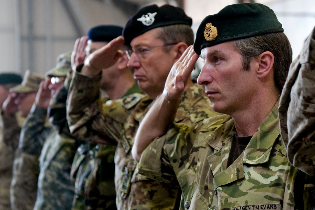 British Army Maj. Gen. Tim Evans, chief of staff for the International Security Assistance Force Joint Command, right, and Italian Maj. Gen. Riccardo Marchio, the command's deputy commander, salute during the playing of the Afghanistan national anthem to begin the change of command ceremony in Kabul, Afghanistan, July 11, 2011.